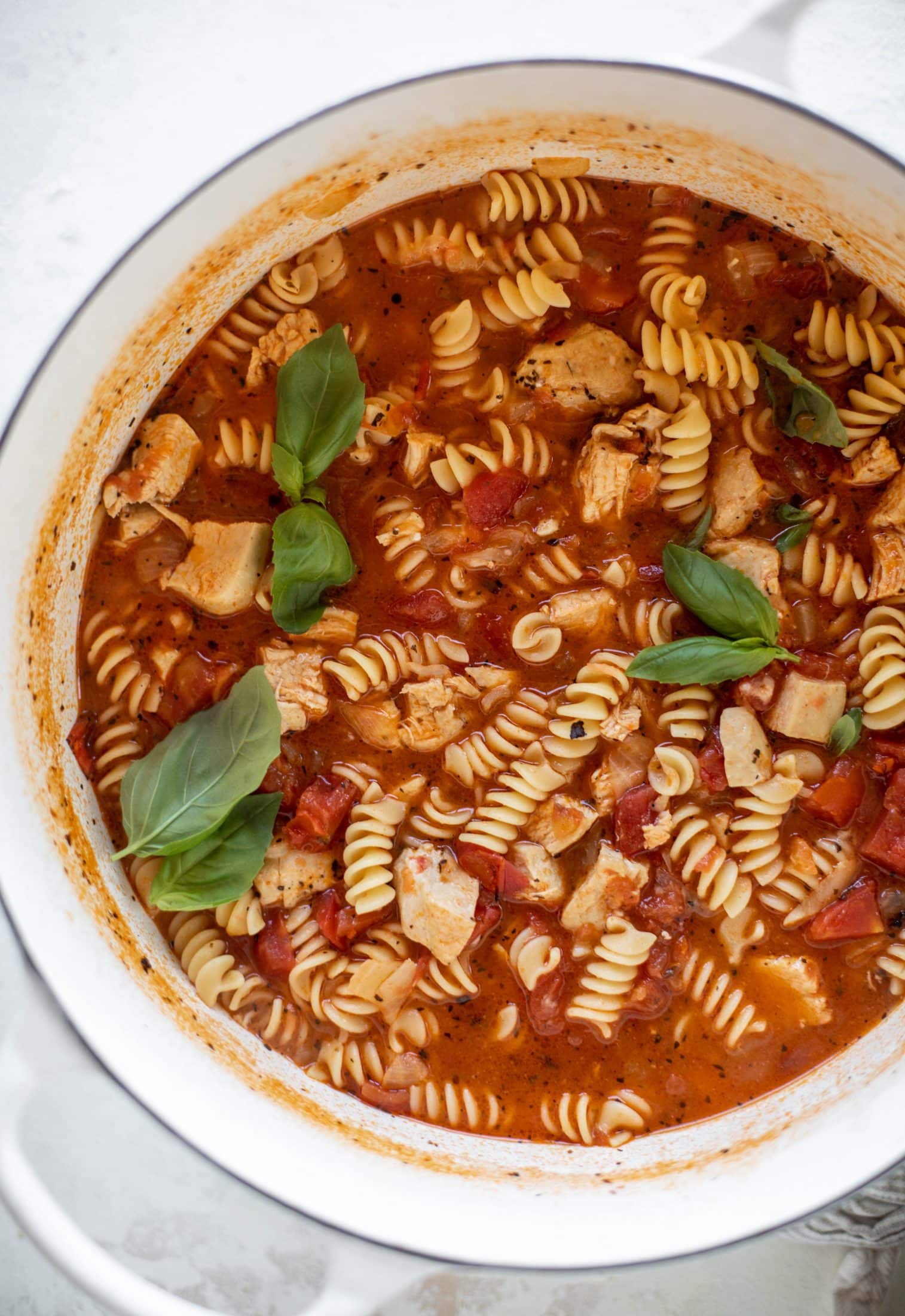 This chicken parmesan soup is ridiculously flavorful and so easy to make! Juicy chicken with pasta, fire roasted tomatoes and mozzarella croutons. Yum!