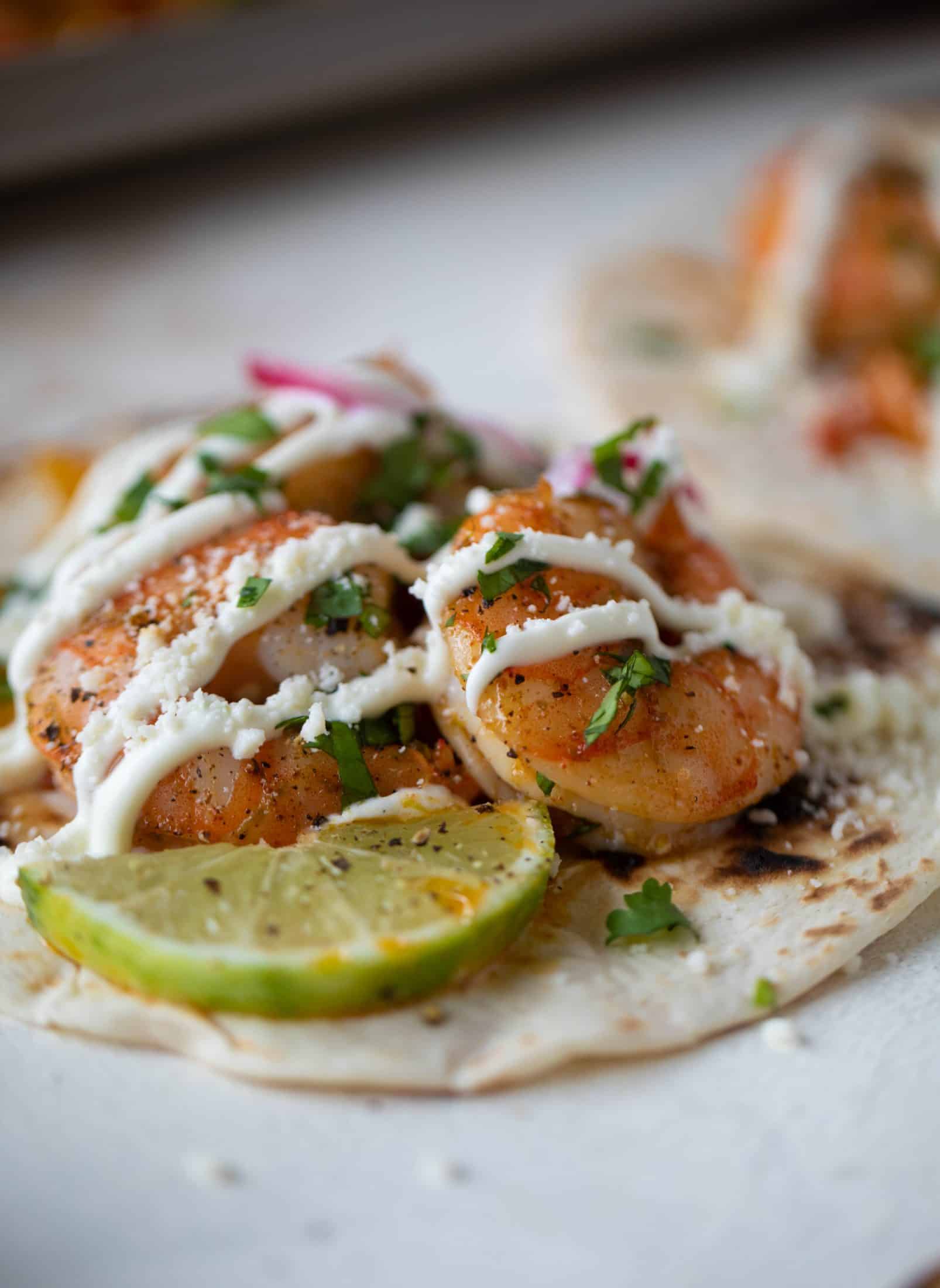 These lime sheet pan shrimp fajitas are the best weeknight meal! Make everything on the sheet pan and serve in warm tortillas. Delicious!