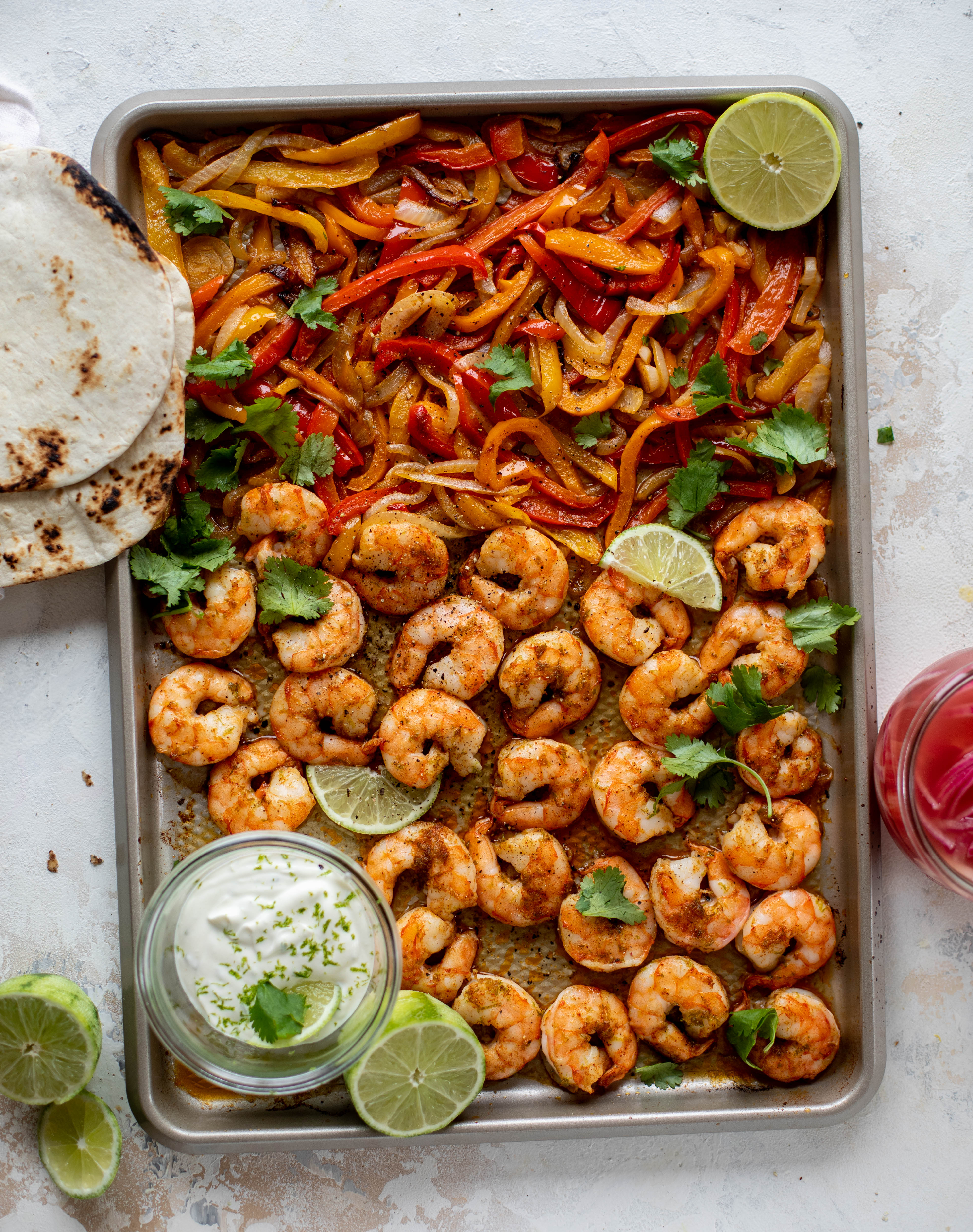 These lime sheet pan shrimp fajitas are the best weeknight meal! Make everything on the sheet pan and serve in warm tortillas. Delicious!
