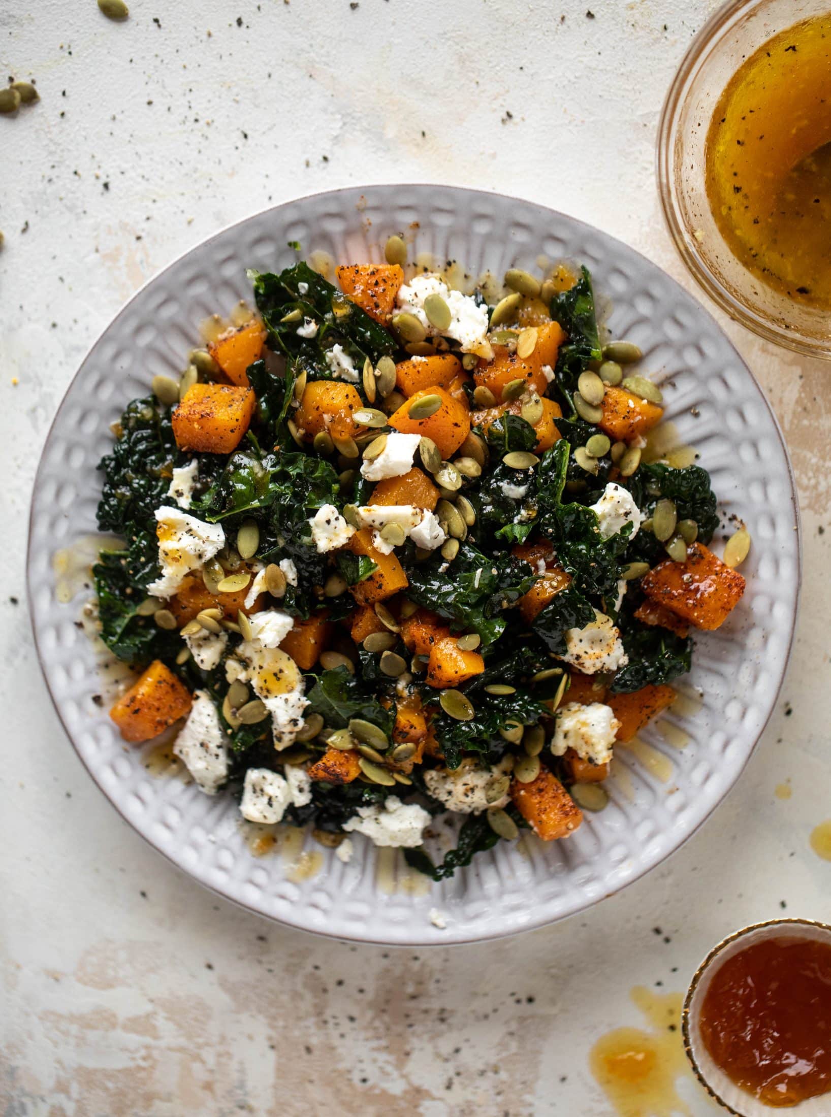 This butternut squash kale salad is so easy and delicious! Roasted, smoky butternut squash, goat cheese, pepitas and apricot vinaigrette.