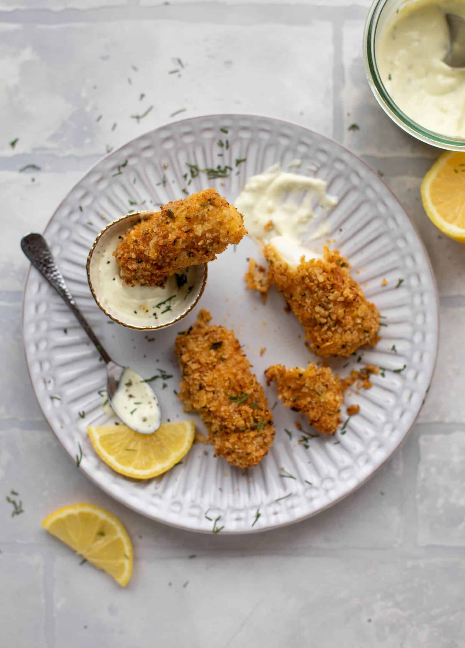 These crispy homemade fish sticks are flavored with lemon and garlic! They are super crunchy and delicious when dipped in the jalapeño tartar sauce.