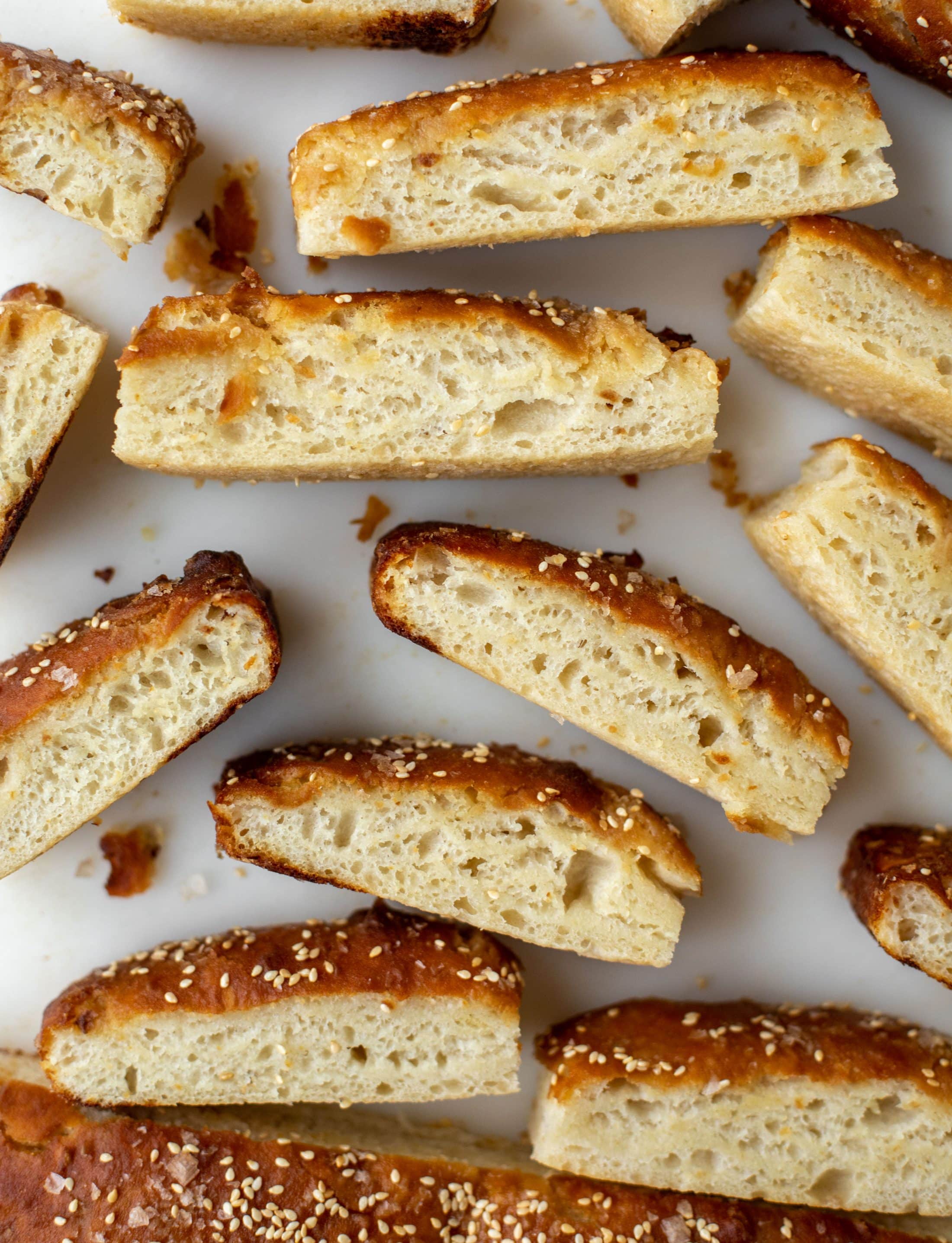 This sesame pretzel focaccia bread is amazing! Almost like a soft pretzel with crispy edges. Serve with a delicious dijon beer cheese.