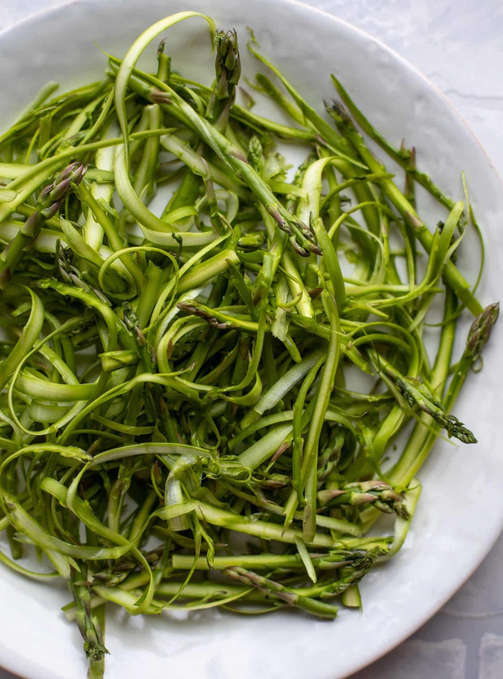 This shaved asparagus salad is tossed with a delicious parmesan vinaigrette, then topped with soft boiled eggs and finished with crunchy garlic breadcrumbs!