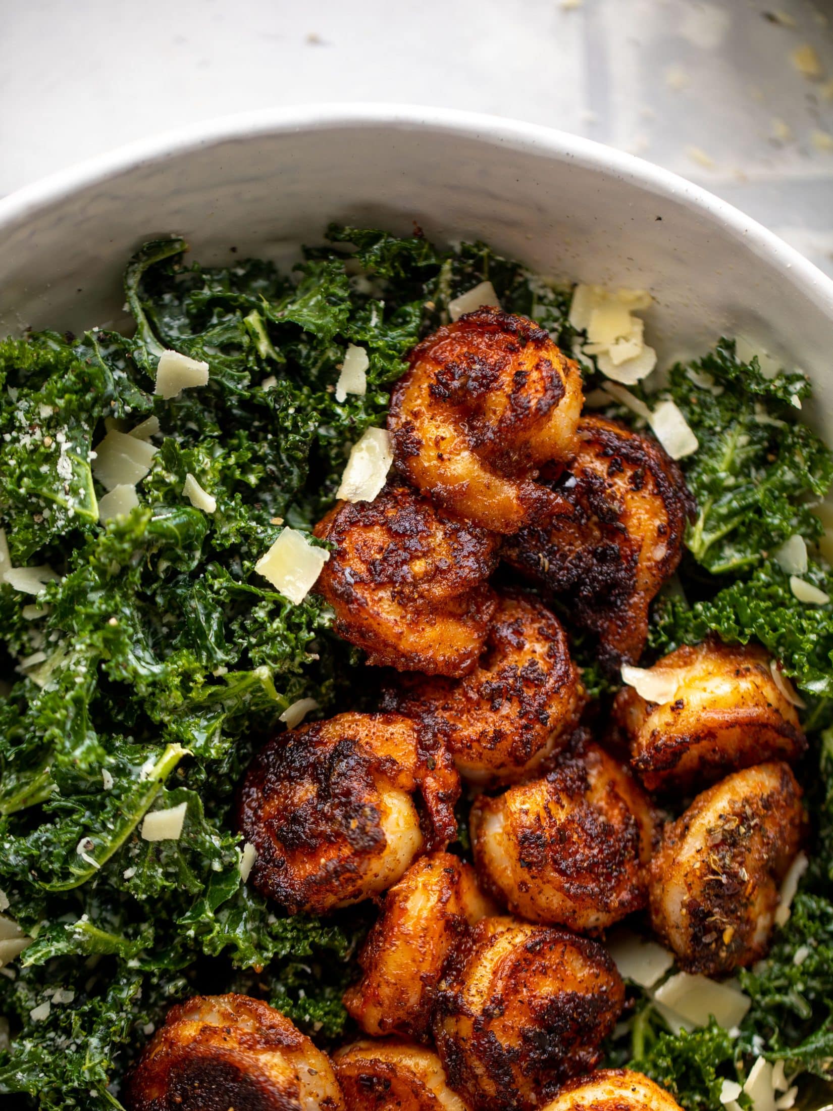 This blackened shrimp kale caesar is loaded with flavor. Spiced, buttery shrimp pan fried until golden, then thrown on kale caesar salad. Delish!