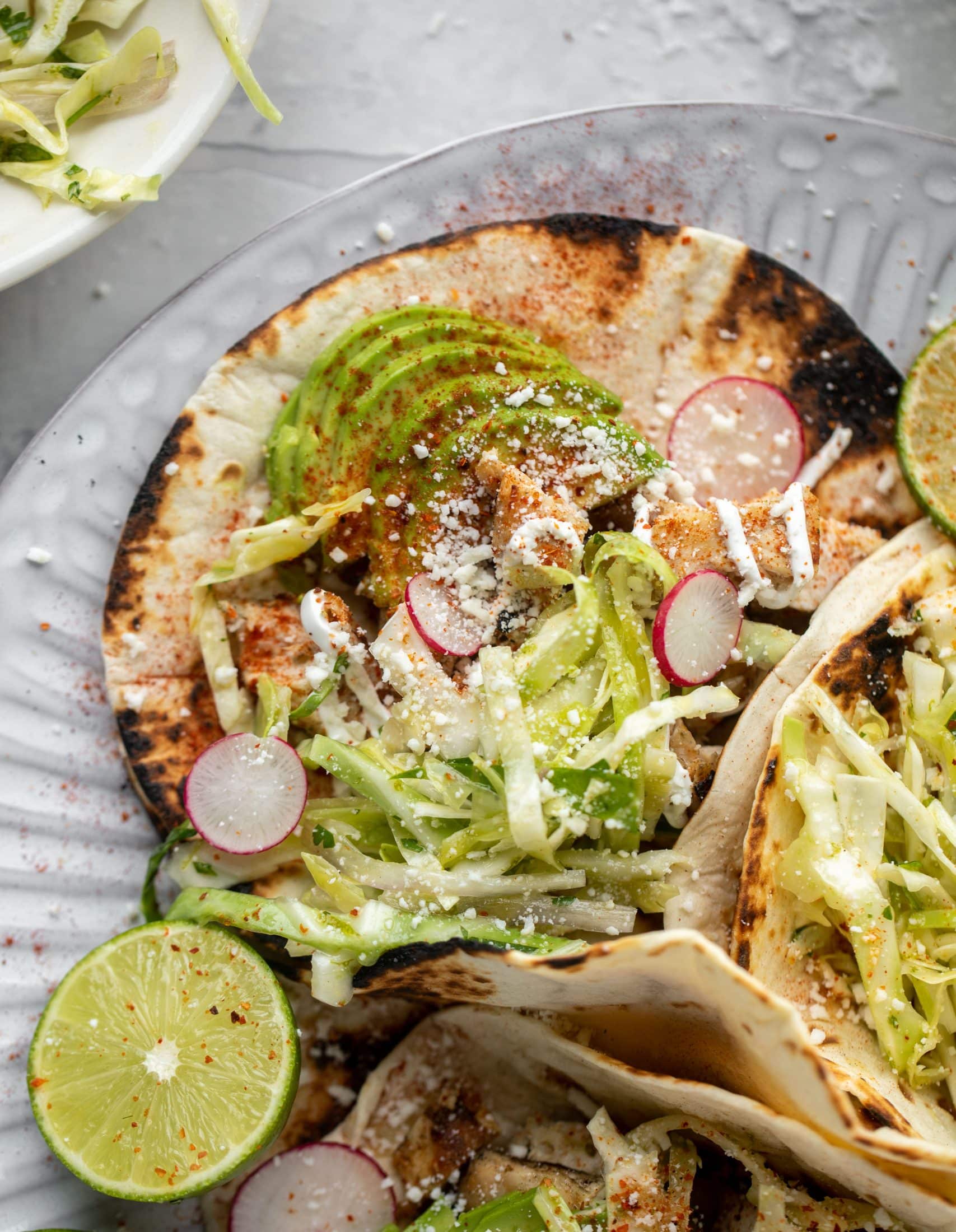 These grilled chicken tacos are easy and flavorful. They are super smoky, then topped with a key lime slaw that is absolutely delicious!