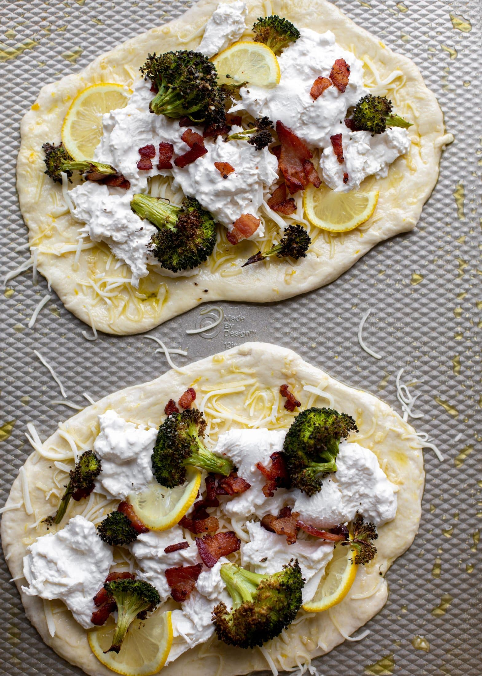 This cheesy lemon flatbread pizza is covered with burrata cheese, parmesan, roasted vegetables and hot honey. It's a flavor dream!