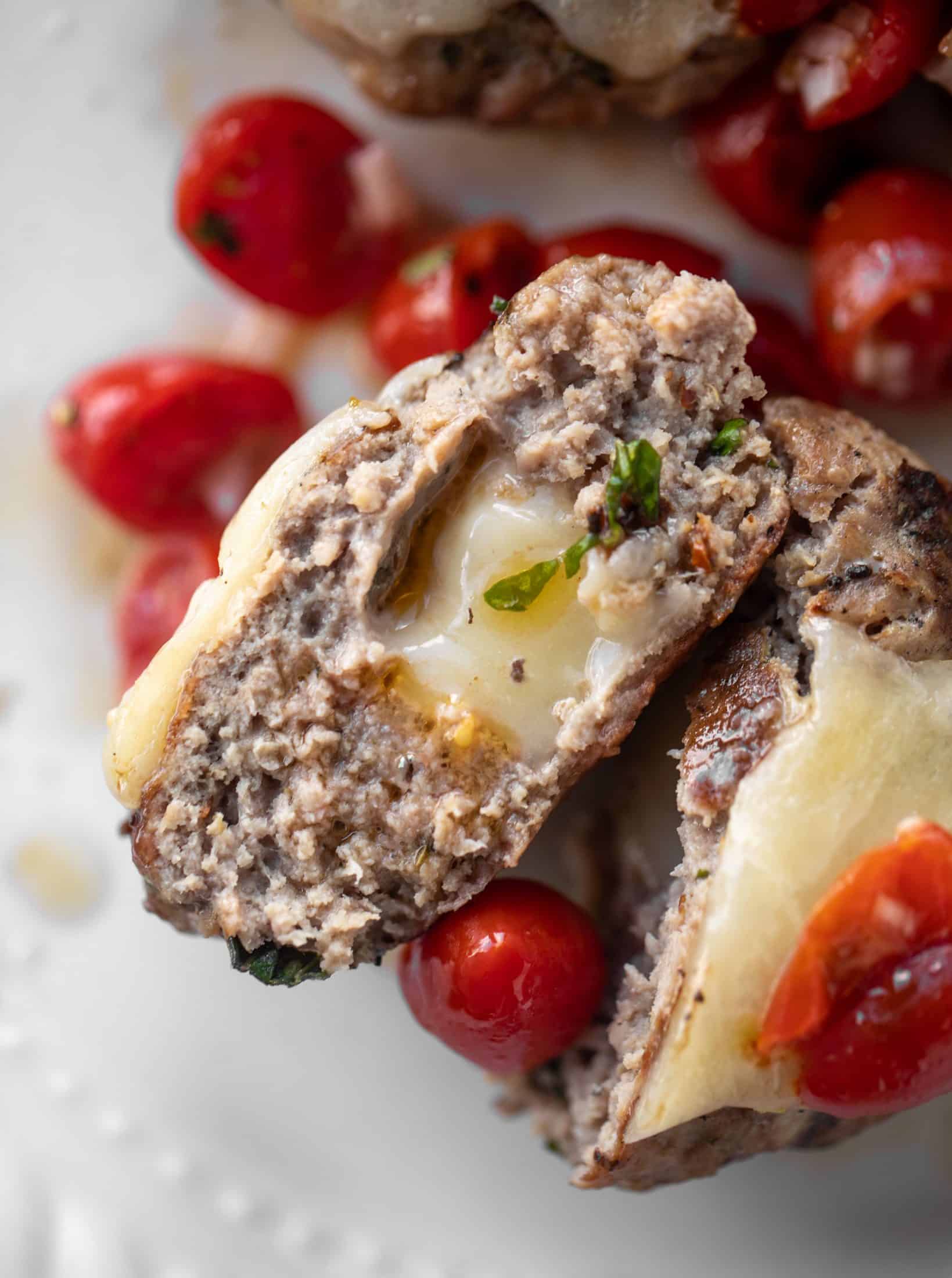 inside of bruschetta chicken burger stuffed with cheese