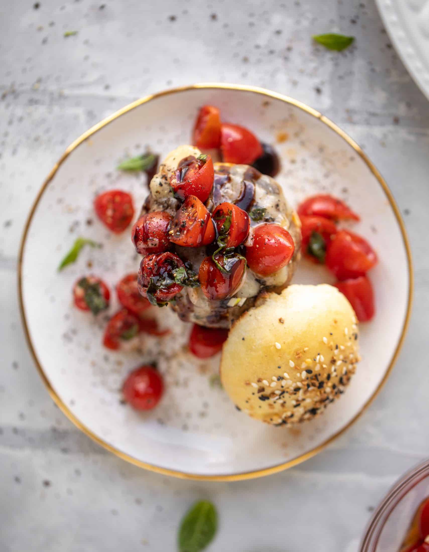 open faced bruschetta chicken burger on a plate