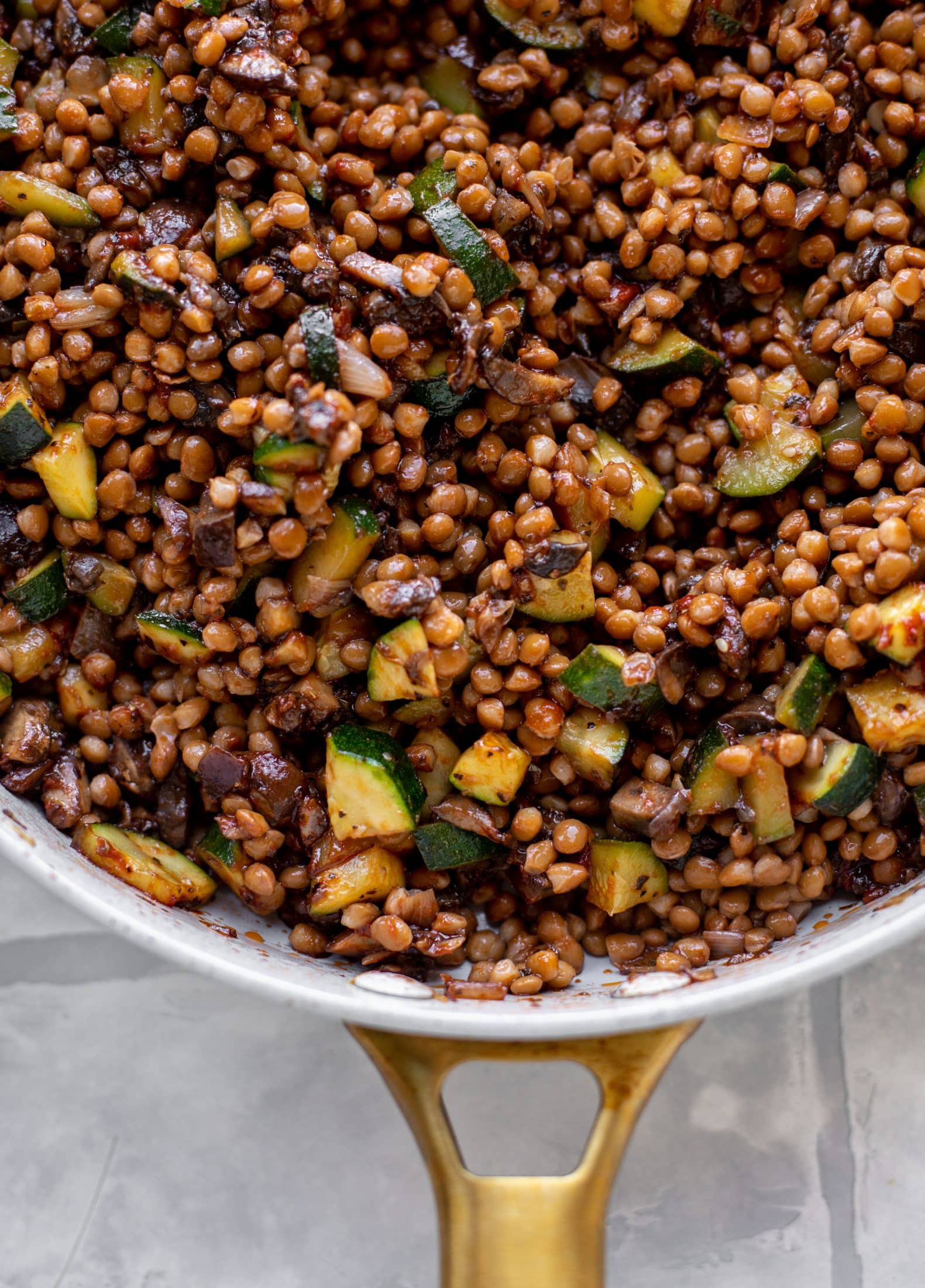 lentils with zucchini and mushrooms in a skillet