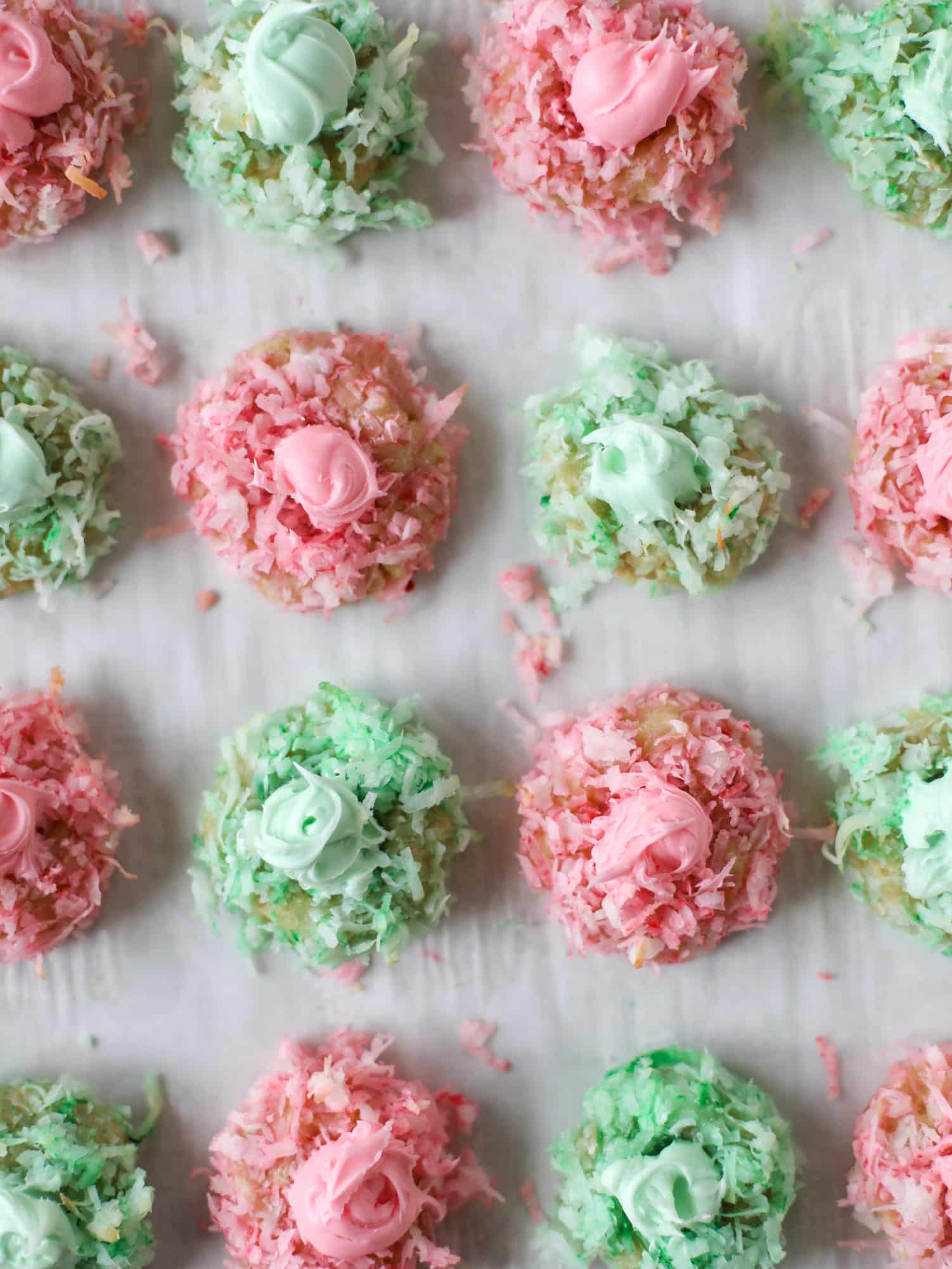 These thumbprint cookies are so perfect for the holiday season. The best butter thumbprint rolled in pink and green coconut and filled with buttercream. So festive! I personally think they look like Grinch cookies - kids love them! I howsweeteats.com #thumbprint #cookies