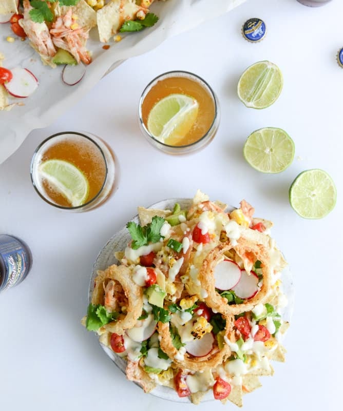 summer BBQ chicken nachos with buttermilk onion rings and white cheddar queso I howsweeteats.com