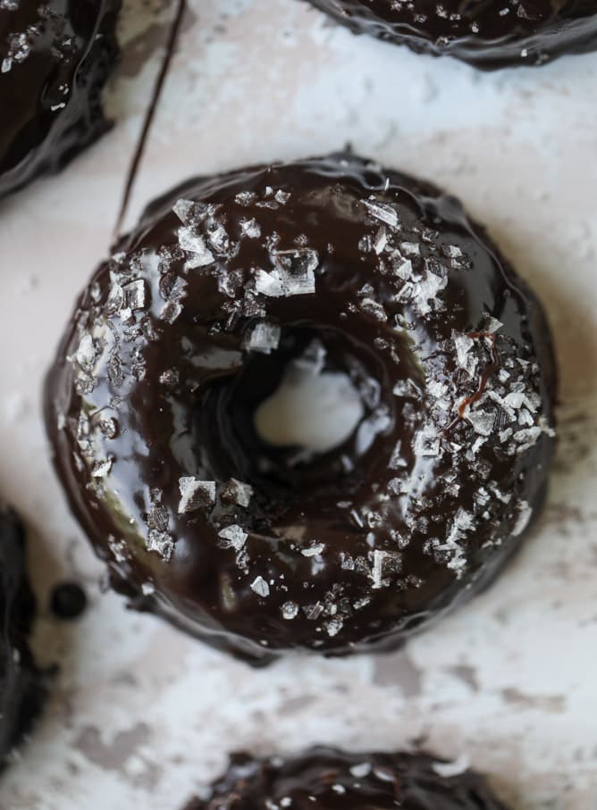 salted dark chocolate fudge donuts I howsweeteats.com #chocolate #donuts #doughtnuts #salted #fudge