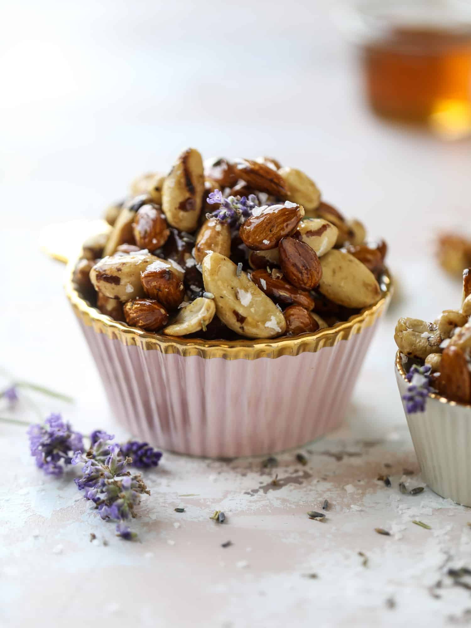 These salted honey lavender nuts are the best snack to make for when you're on the go or when you need a perfect appetizer for your dinner party. Roasted, sweet and salty with a hint of lavender makes these irresistible! I howsweeteats.com #honey #lavender #nuts #salted #almonds #cashews #snacks #appetizers