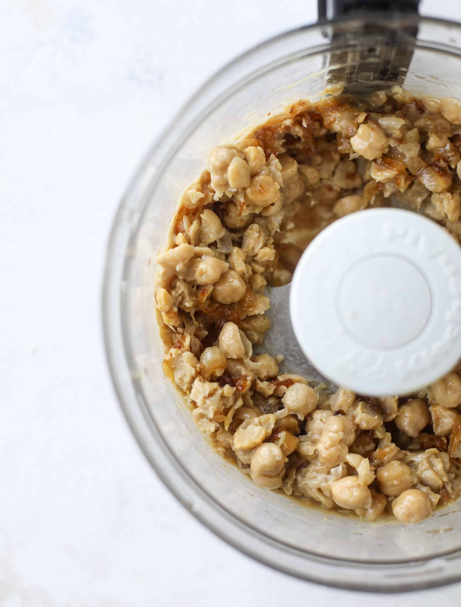 Here you can find out how to make the perfect hummus platter! This trio includes caramelized onion hummus, smoky black bean hummus and roasted red pepper white bean hummus, along with a couscous salad and quick tzatziki! I howsweeteats.com #hummus #platter #appetizer #snack #chickpeas #healthy #blackbeans #yogurt #tzatziki