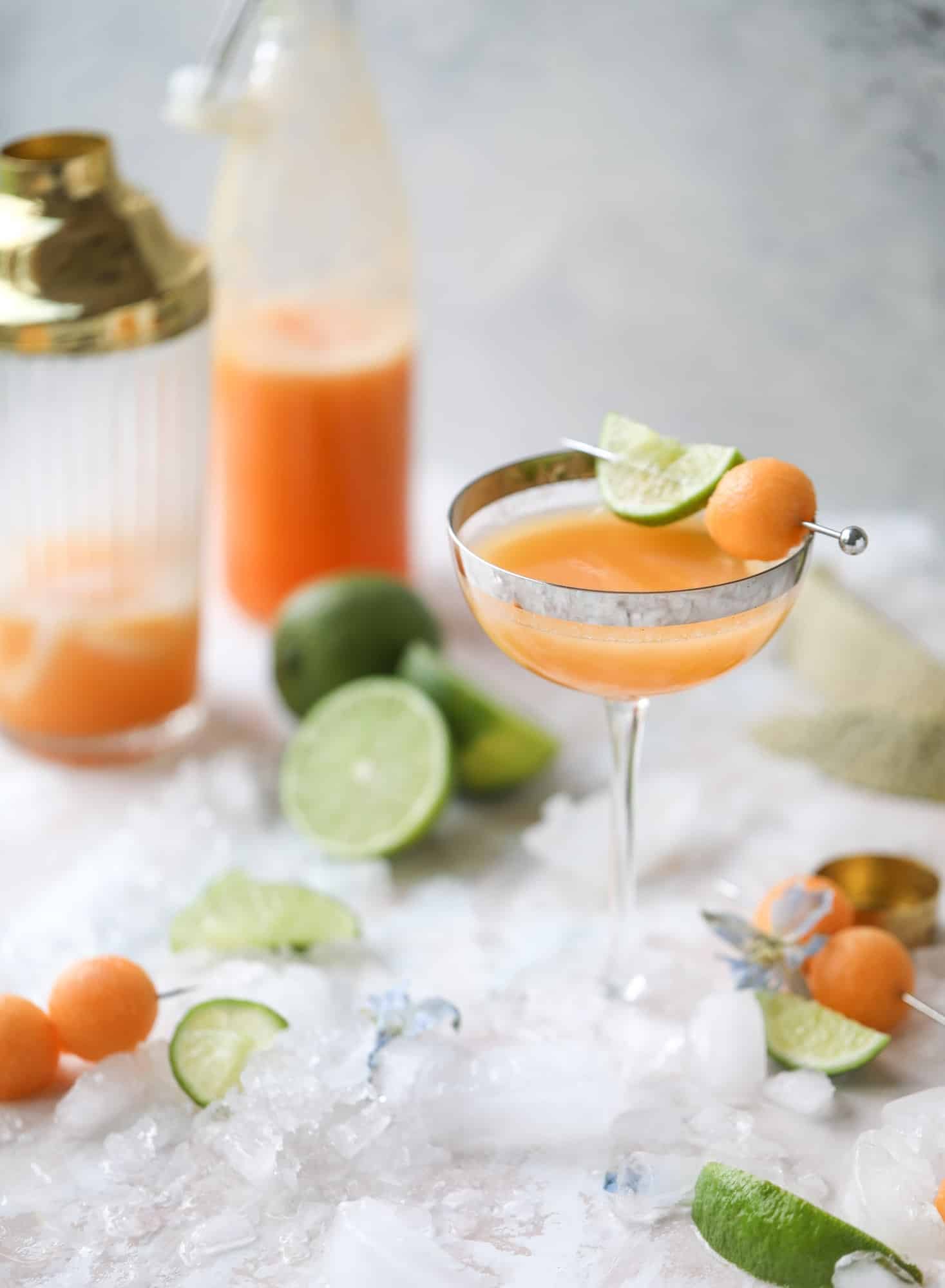 This cantaloupe daiquiri is the perfect way to celebrate summer! Freshly juiced melon, lime juice, rum and maraschino cherries - it's refreshing and cool and a fantastic cocktail to have during happy hour! Isn't the color amazing too?! I howsweeteats.com #cantaloupe #cocktail #daiquiri #lime #rum #summer