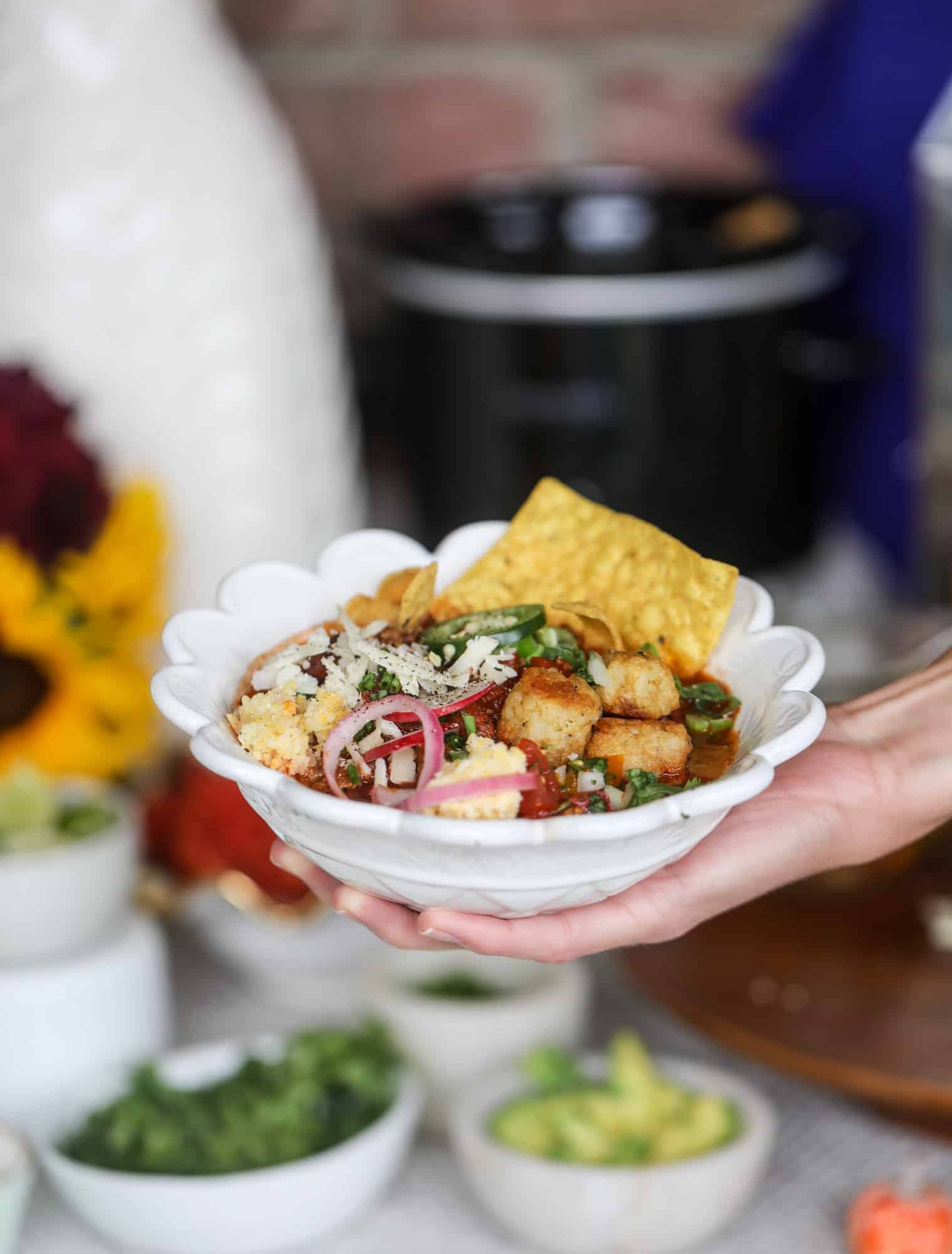 This is the best way to set up a chili bar! All my tips and tricks for setting up a perfect chili bar with multiple toppings, a nacho bar, hot dogs - all done with prep to make the day of the party super easy! This chili bar is goals. I howsweeteats.com #chili #bar #how #to