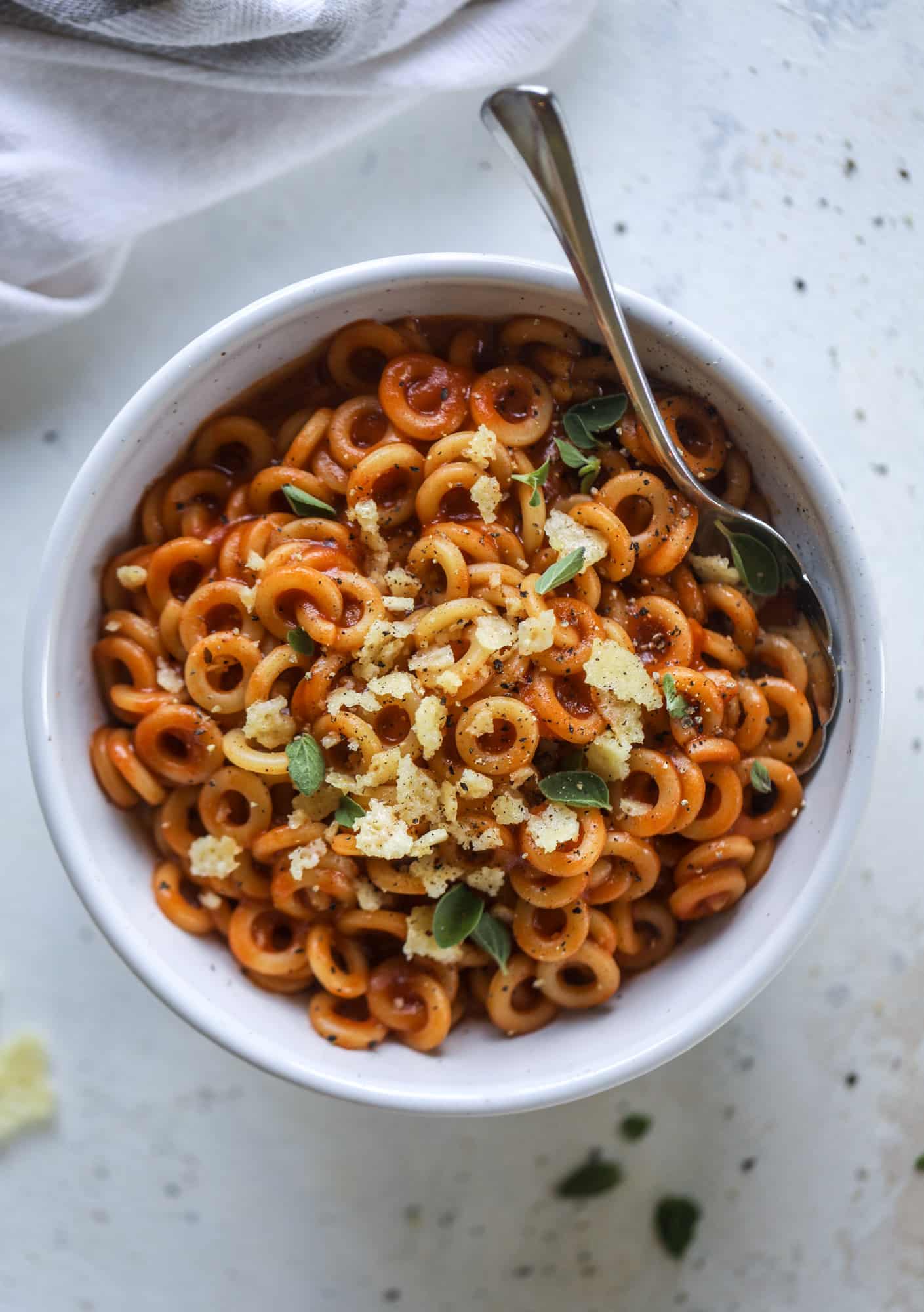 These homemade spaghettios are the ultimate comfort food! They come together in less than 30 minutes, are super easy and flavorful and topped with crispy crunchy manchego cheese that takes the taste over the top! I howsweeteats.com #homemade #spaghettios