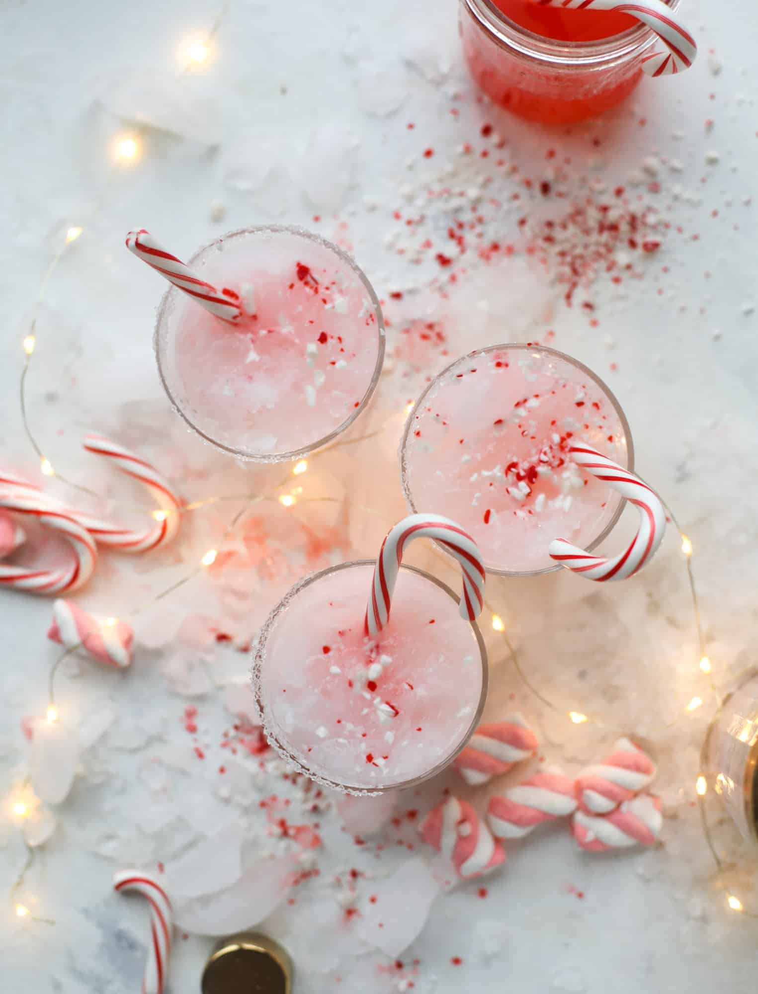 This pink peppermint cocktail is full of holiday cheer! Candy cane vodka, creme de cacao, vanilla and a drop of cream come together to create the perfect iced holiday drink that tastes like a treat! I howsweeteats.com #pinkpeppermint #cocktail