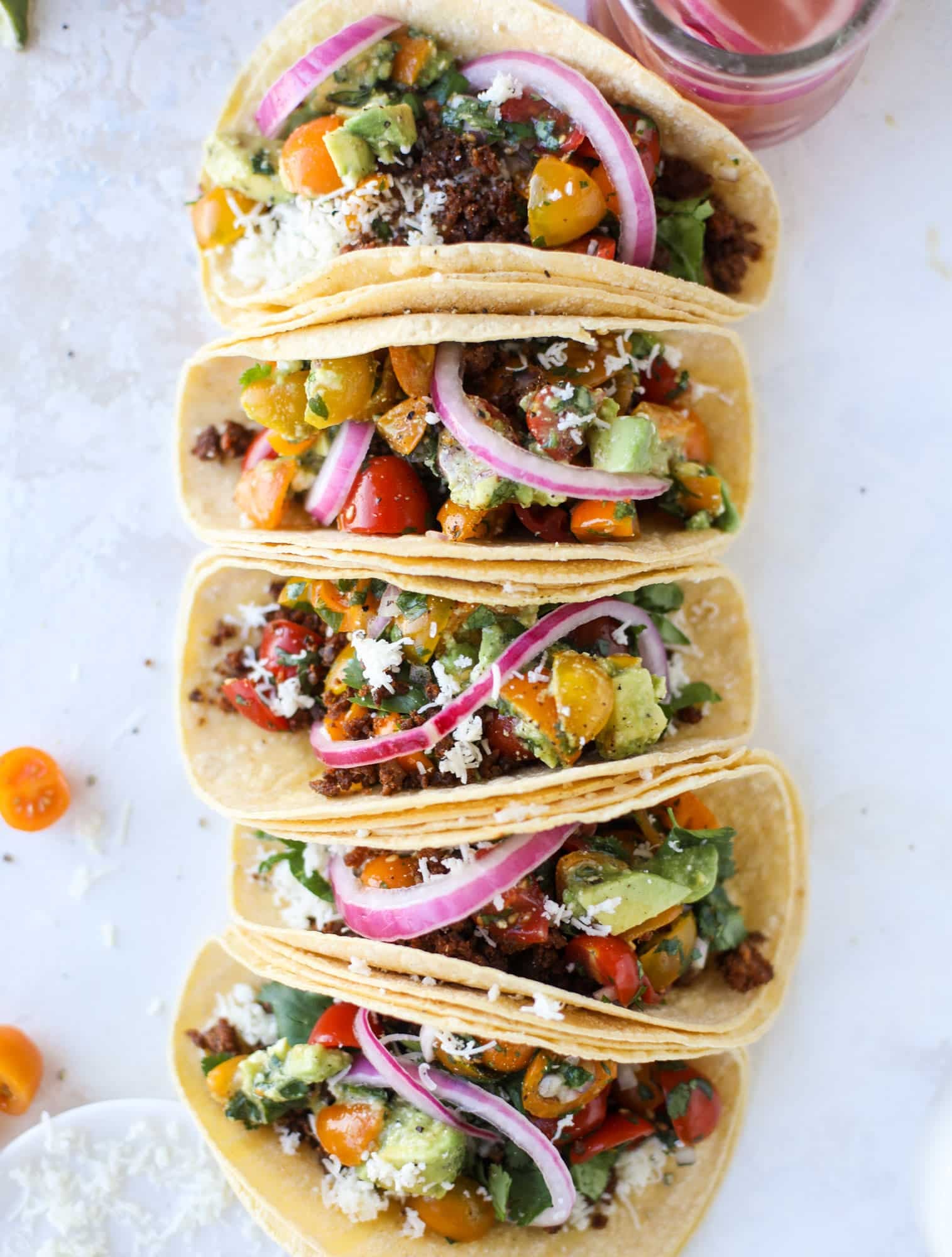 Weeknight ground beef tacos that are anything like the 90s! These are made with a homemade taco seasoning and served with the perfect toppings! I howsweeteats.com #groundbeef #tacos