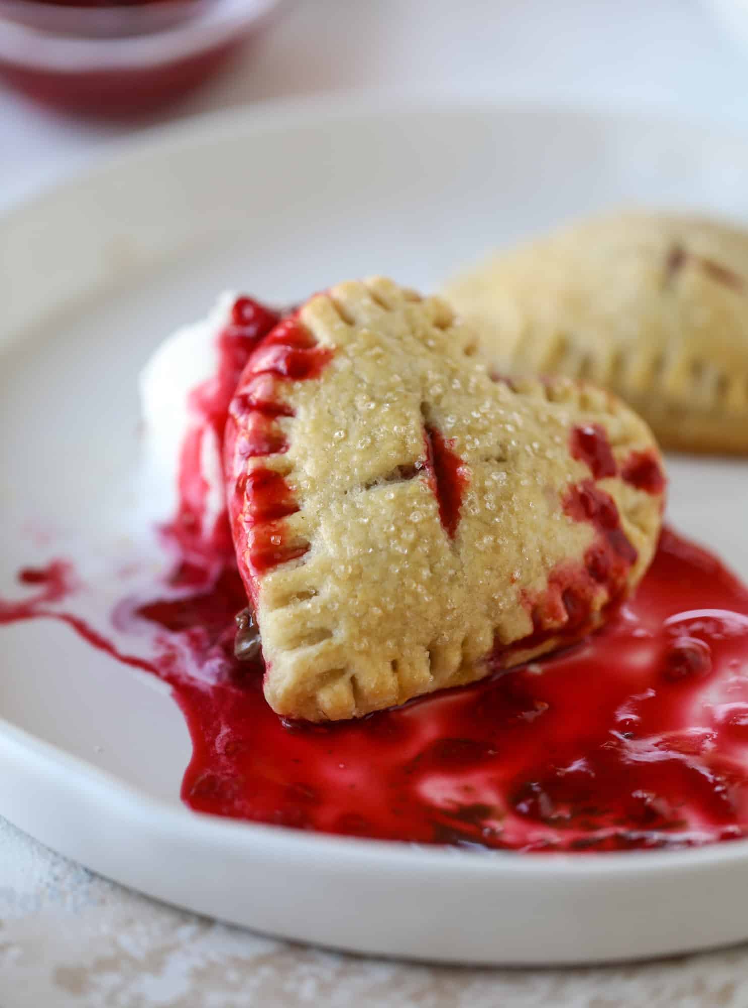 These adorable mini heart pies are filled with a homemade raspberry compote and creamy, chocolatey nutella. So fun and easy to make! I howsweeteats.com #heart #pie