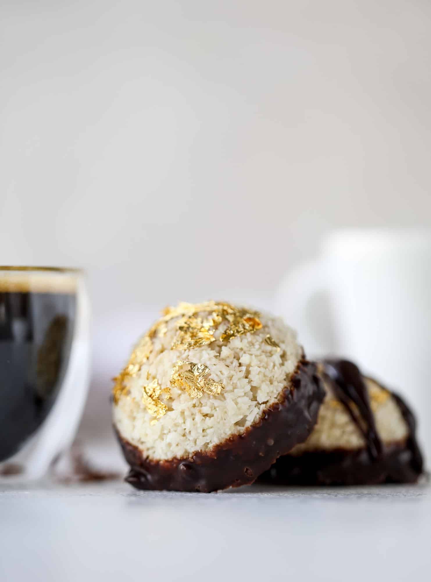 Classic chewy, slightly gooey coconut macaroons dipped in an irish cream chocolate ganache. Easy to make and gluten free too! I howsweeteats.com #irishcream #coconutmacaroons
