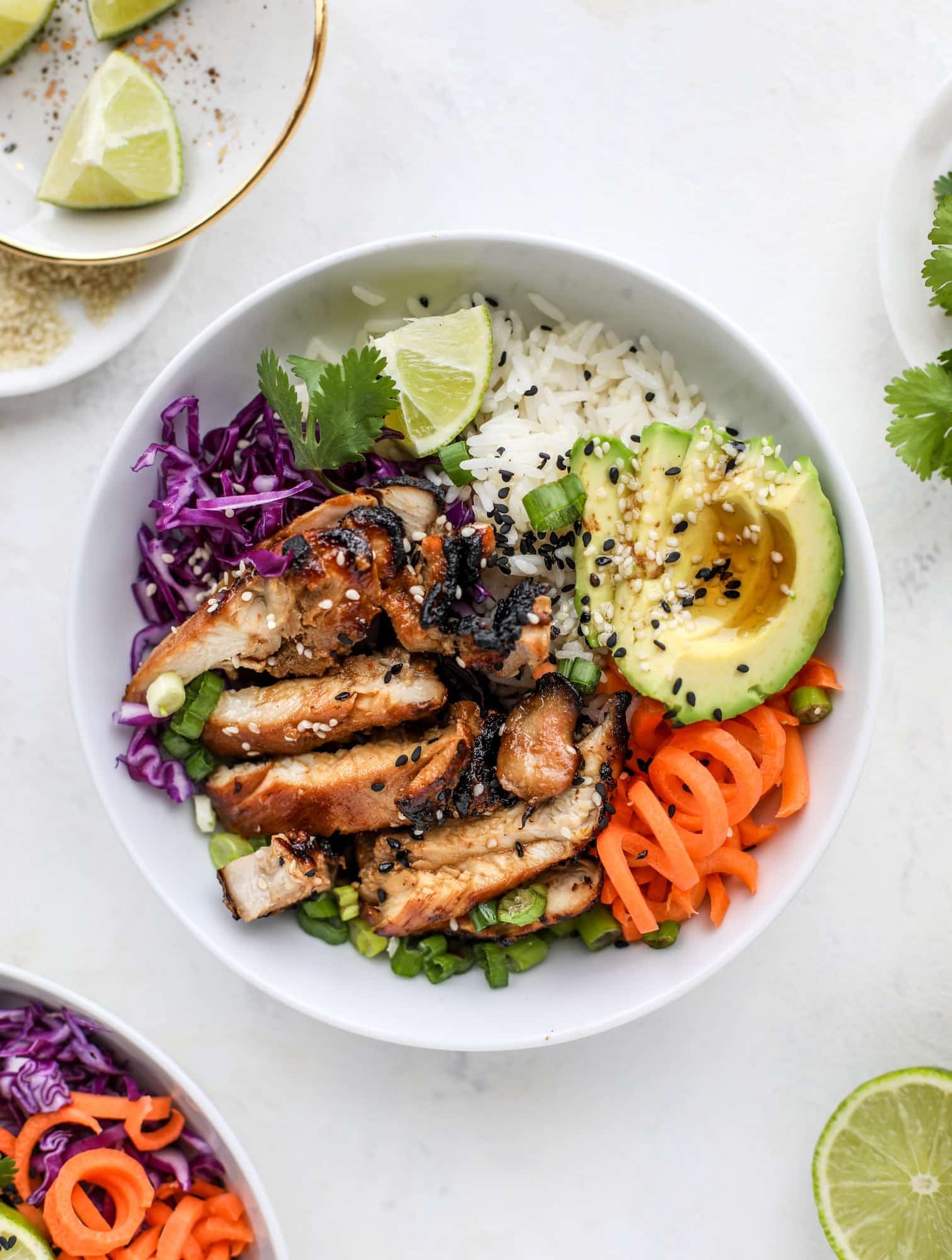 Korean chicken bowls are loaded with flavor: toasted sesame, soy sauce and lime come together over coconut rice and avocado to create a delicious meal! I howsweeteats.com #korean #chicken