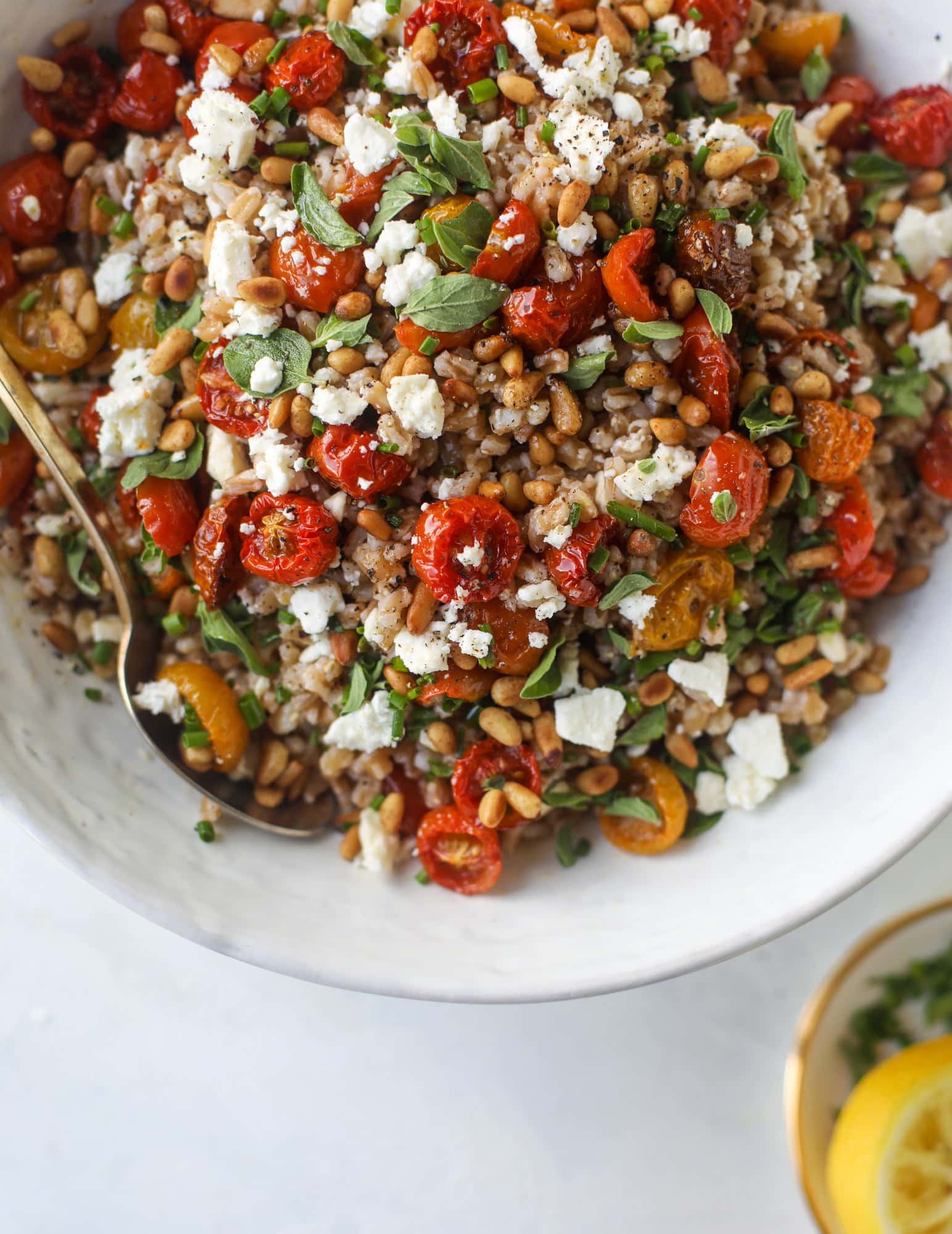 A tomato farro salad that is sweet from the slow roasted tomatoes, tangy from the feta cheese, chewy from the farro and bright from the lemon!