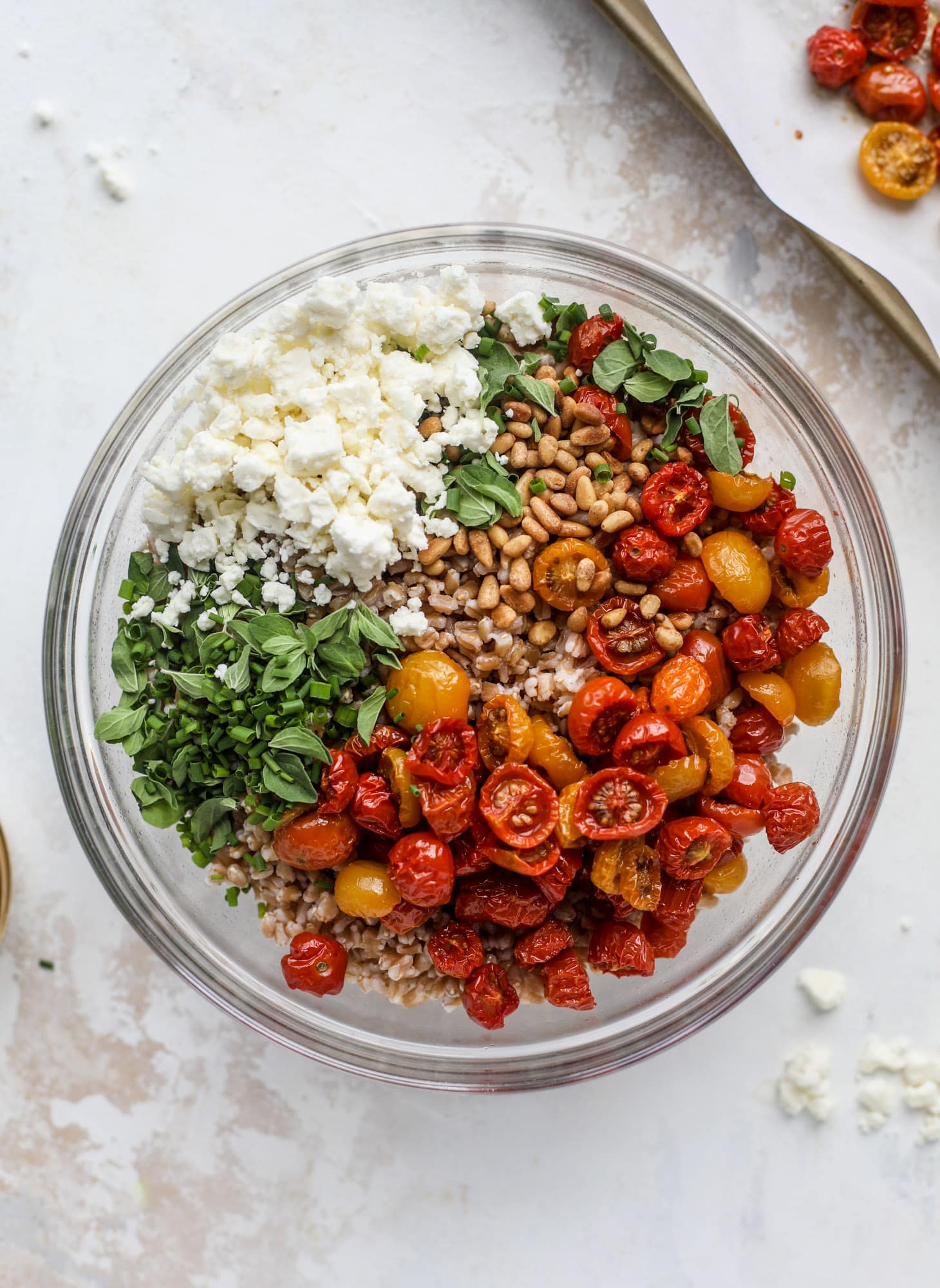 A tomato farro salad that is sweet from the slow roasted tomatoes, tangy from the feta cheese, chewy from the farro and bright from the lemon!