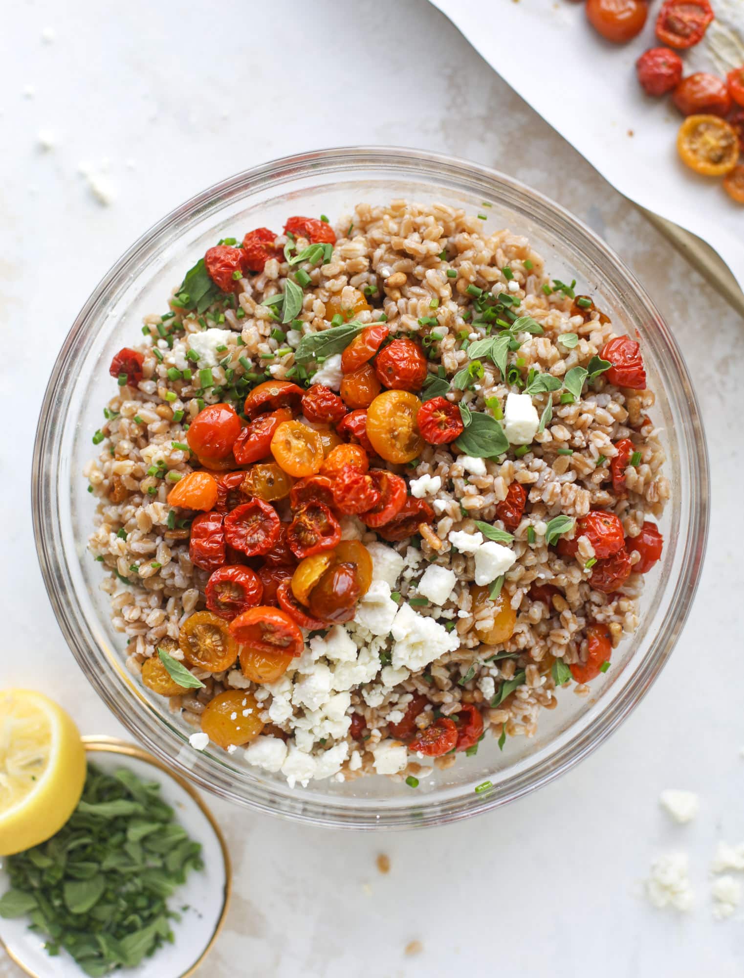 A tomato farro salad that is sweet from the slow roasted tomatoes, tangy from the feta cheese, chewy from the farro and bright from the lemon!