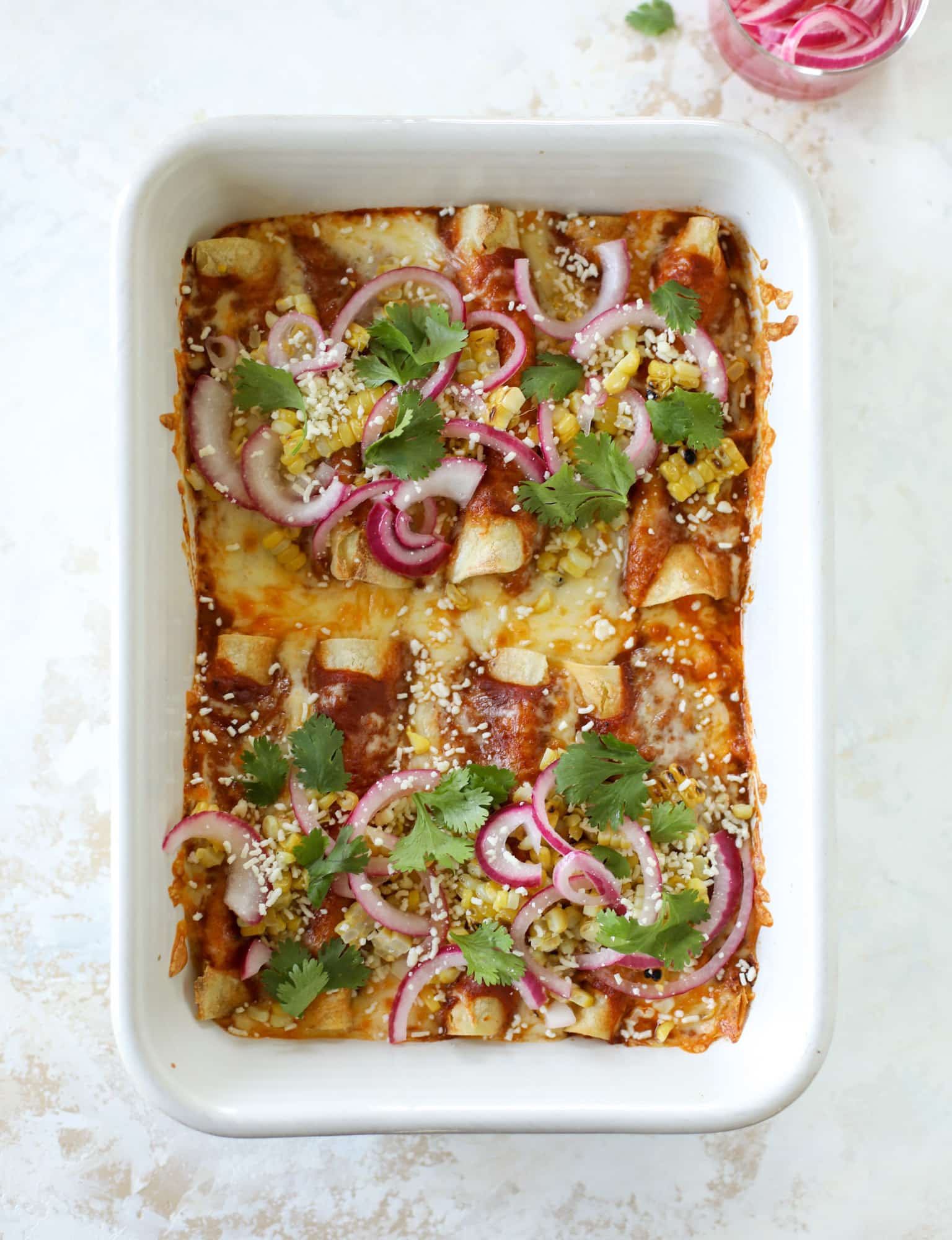 These grilled corn enchiladas are the perfect summer meal! Grilled corn, zucchini, homemade sauce and cheese come together for a flavor explosion!