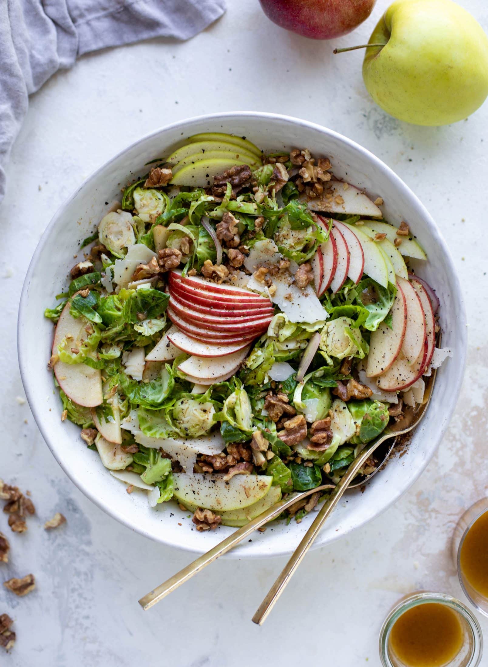 This crunchy brussels sprouts apple salad is filled with sprouts, apples, shallots, cinnamon toasted walnuts and drizzled with a brown butter dressing.