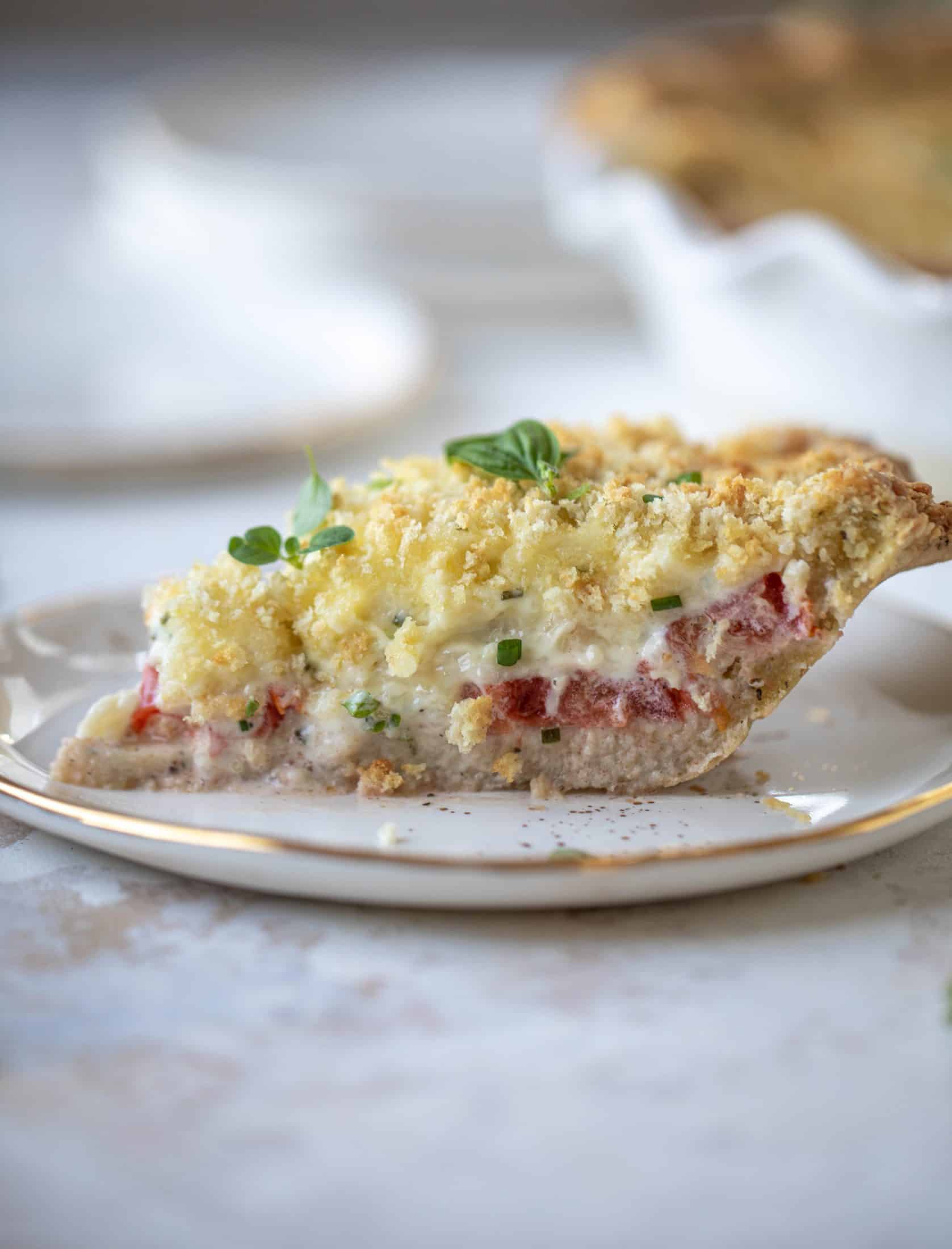 This summer tomato pie is the best dinner ever! Cheddar herb crust, ripe, juicy tomatoes and a cheesy, crunchy layer on top. It's irresistible. 