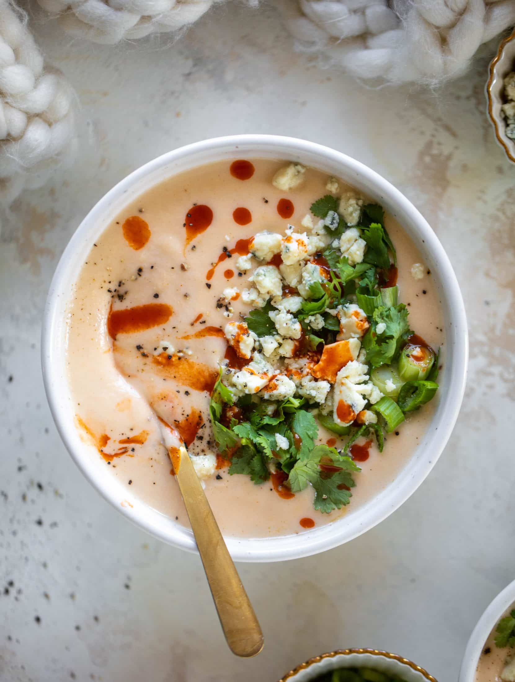 This buffalo cauliflower soup is creamy and decadent and silky smooth! Made with cheddar, wing sauce, blue cheese and all the fixins! 