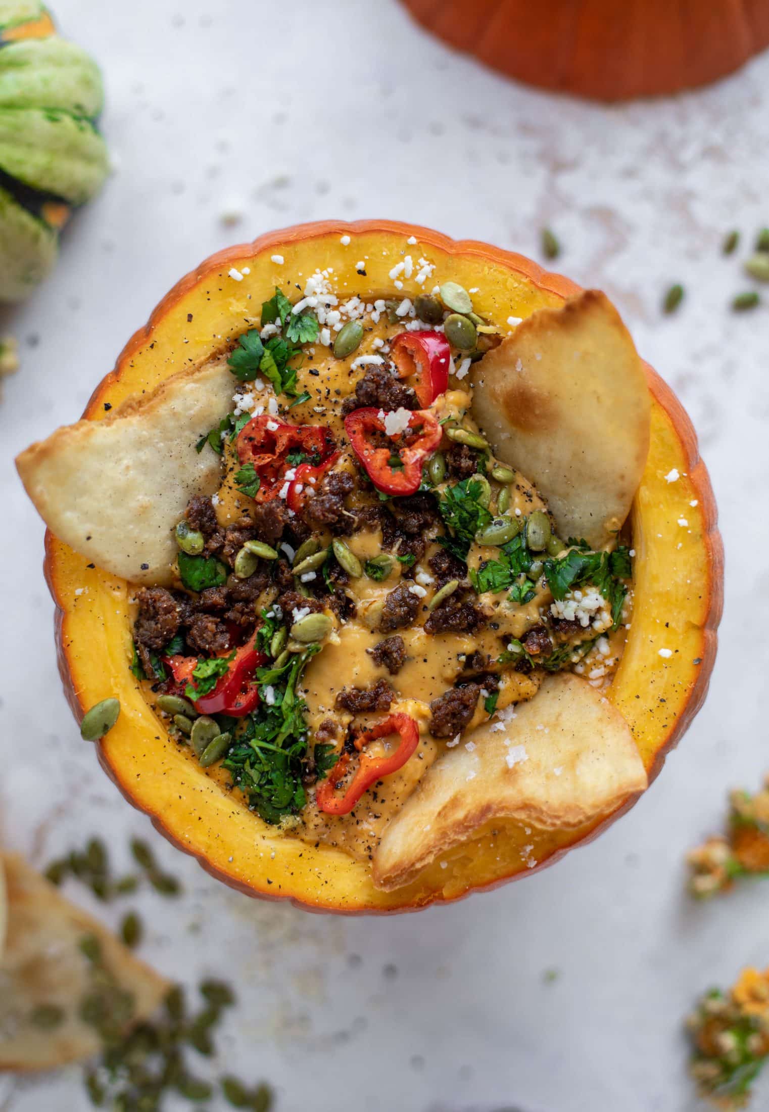 This pumpkin queso fundido is the perfect indulgence for fall. Warm pumpkin queso topped with chroizo, pepitas and jalapeños. It's delish! 