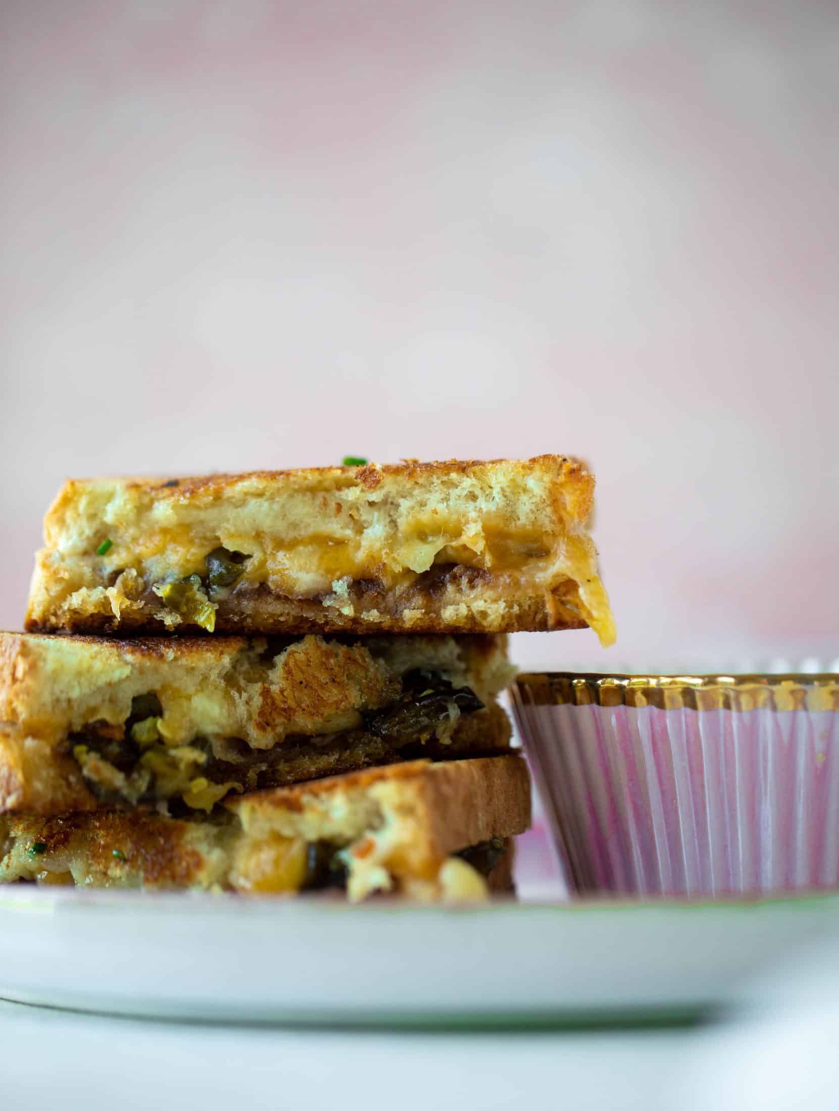 This bacon grilled cheese is filled with sharp cheddar and candied jalapeños! Served alongside a soup dipped for the ultimate comforting meal.