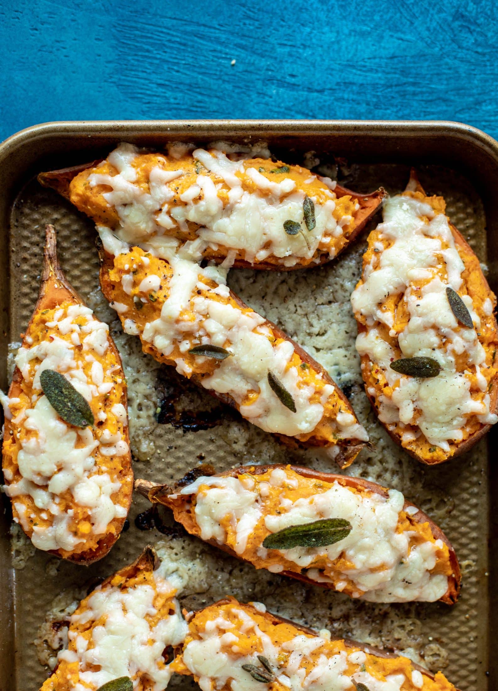 These twice baked sweet potatoes are whipped with crispy sage and pumpkin puree! Topped with cheese and baked until melty, they are super delish.