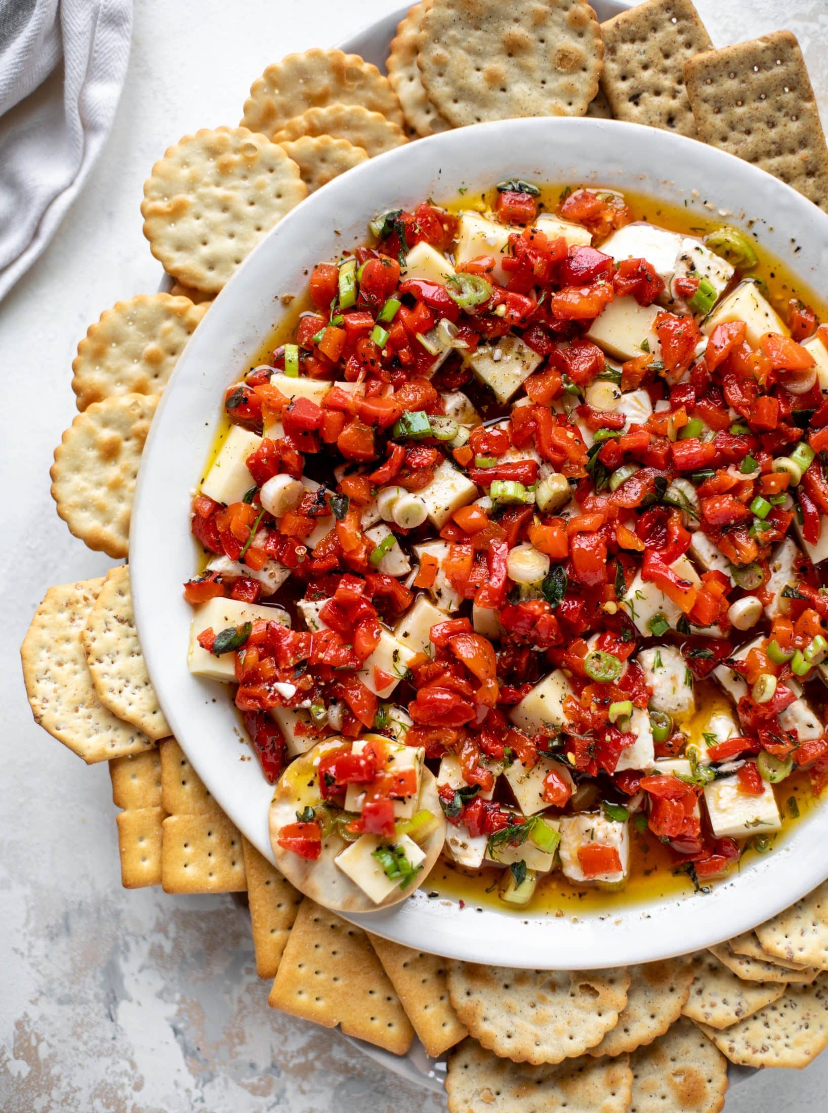 This marinated cheese recipe is perfect for Christmas! Make it ahead and transport it easily to your destination. It's absolutely delicious.