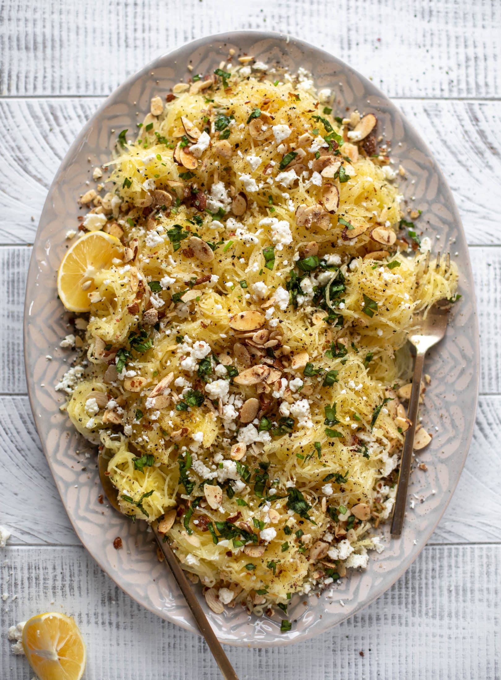 This lemon spaghetti squash is tossed in a lemon garlic butter and topped with feta, sliced toasted almonds and fresh herbs. It's delicious!