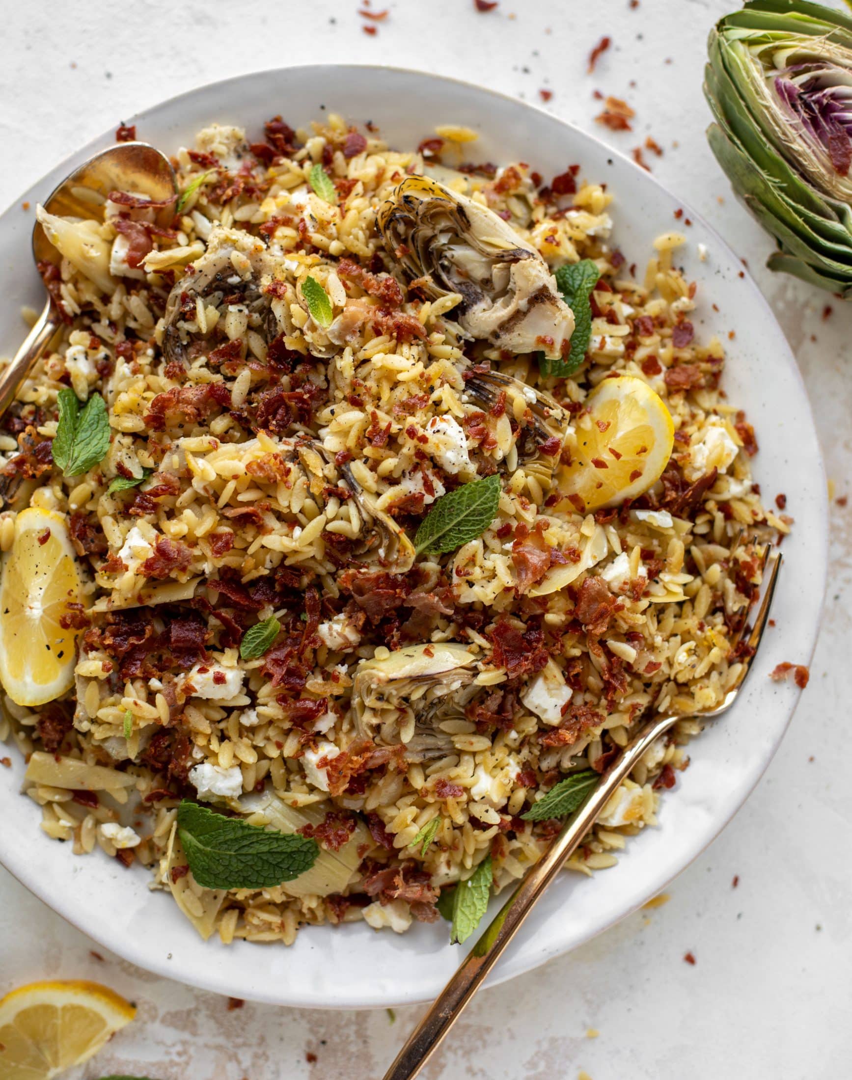 This crispy orzo is a wonderful spring dish. Artichoke hearts, lemon, goat cheese and herbs all topped with a sprinkling of crunchy prosciutto. 