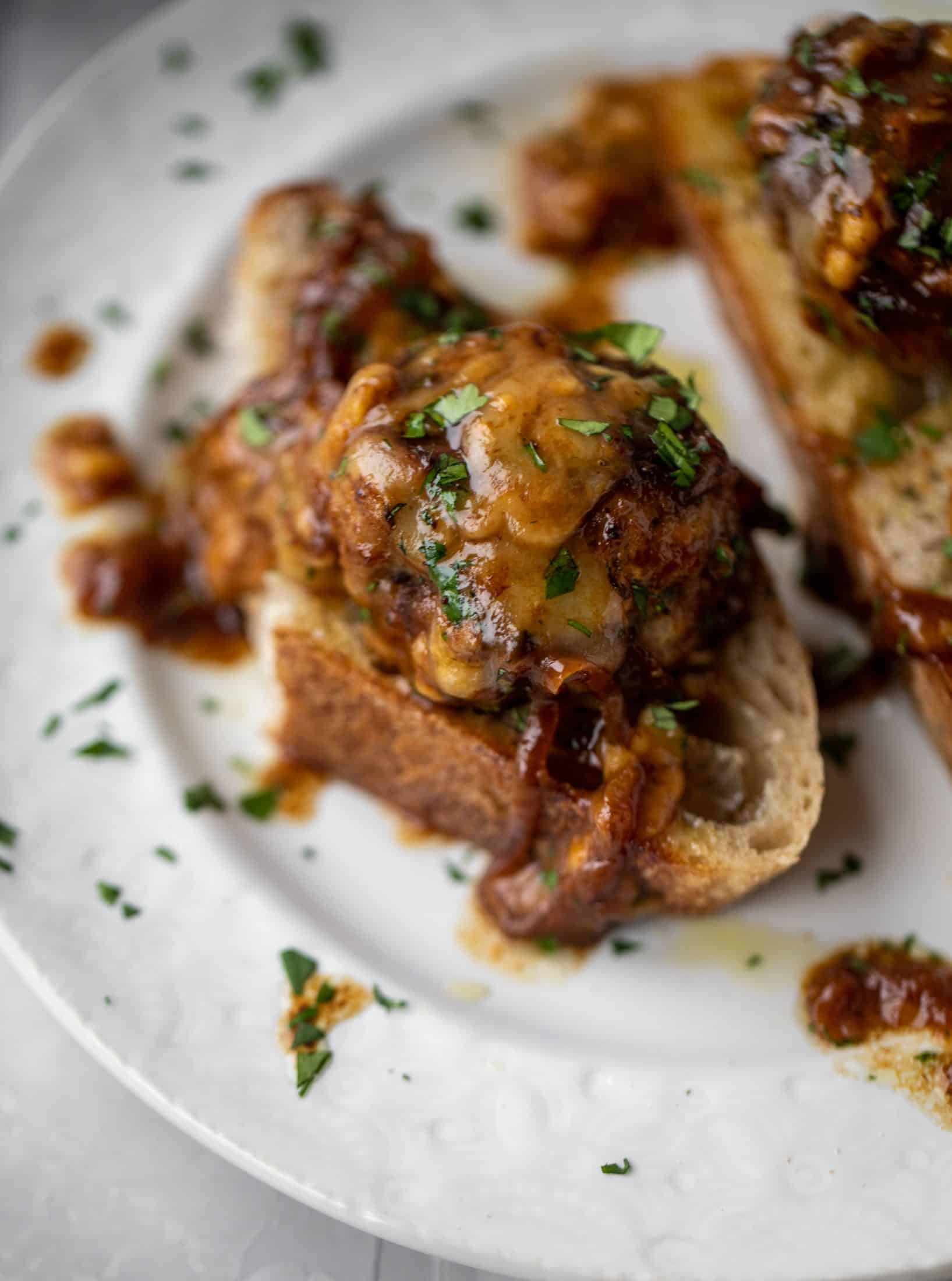 These french onion meatballs are super delicious! All the flavors of french onion soup made into juicy meatballs. Cheesy, saucy goodness!