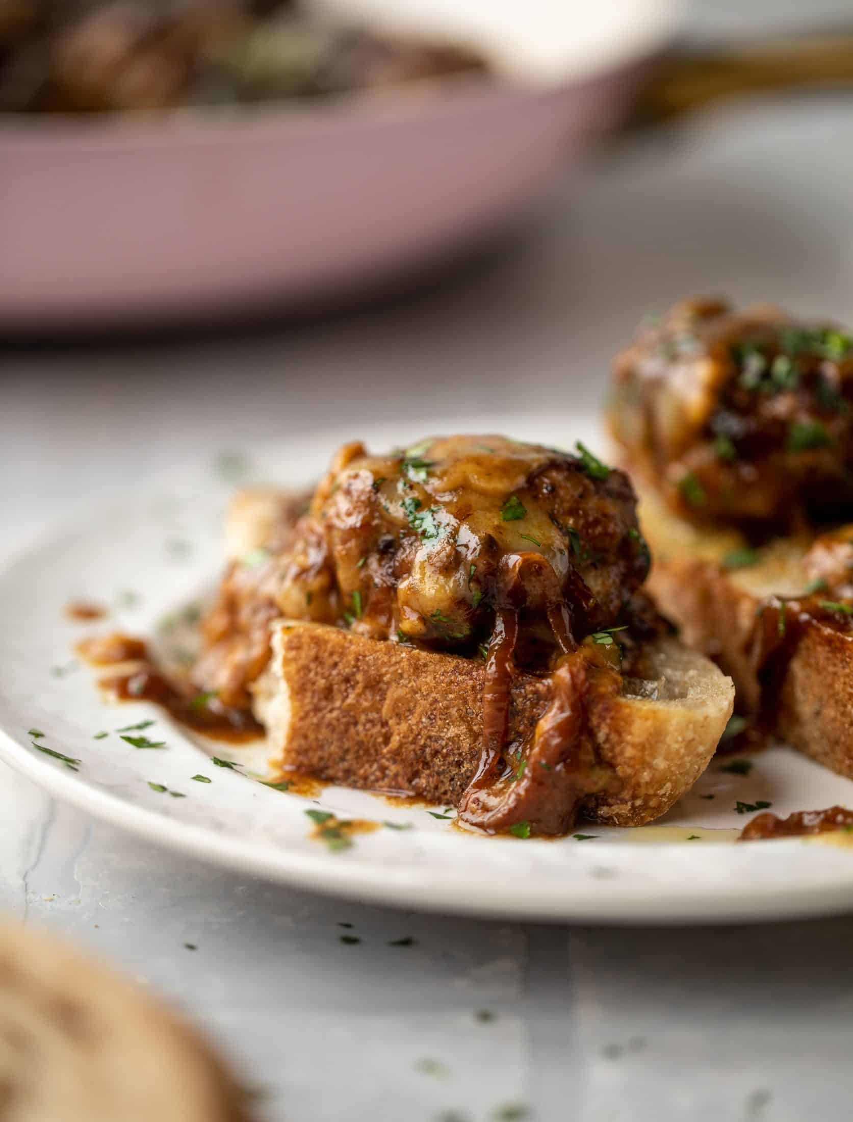 These french onion meatballs are super delicious! All the flavors of french onion soup made into juicy meatballs. Cheesy, saucy goodness!