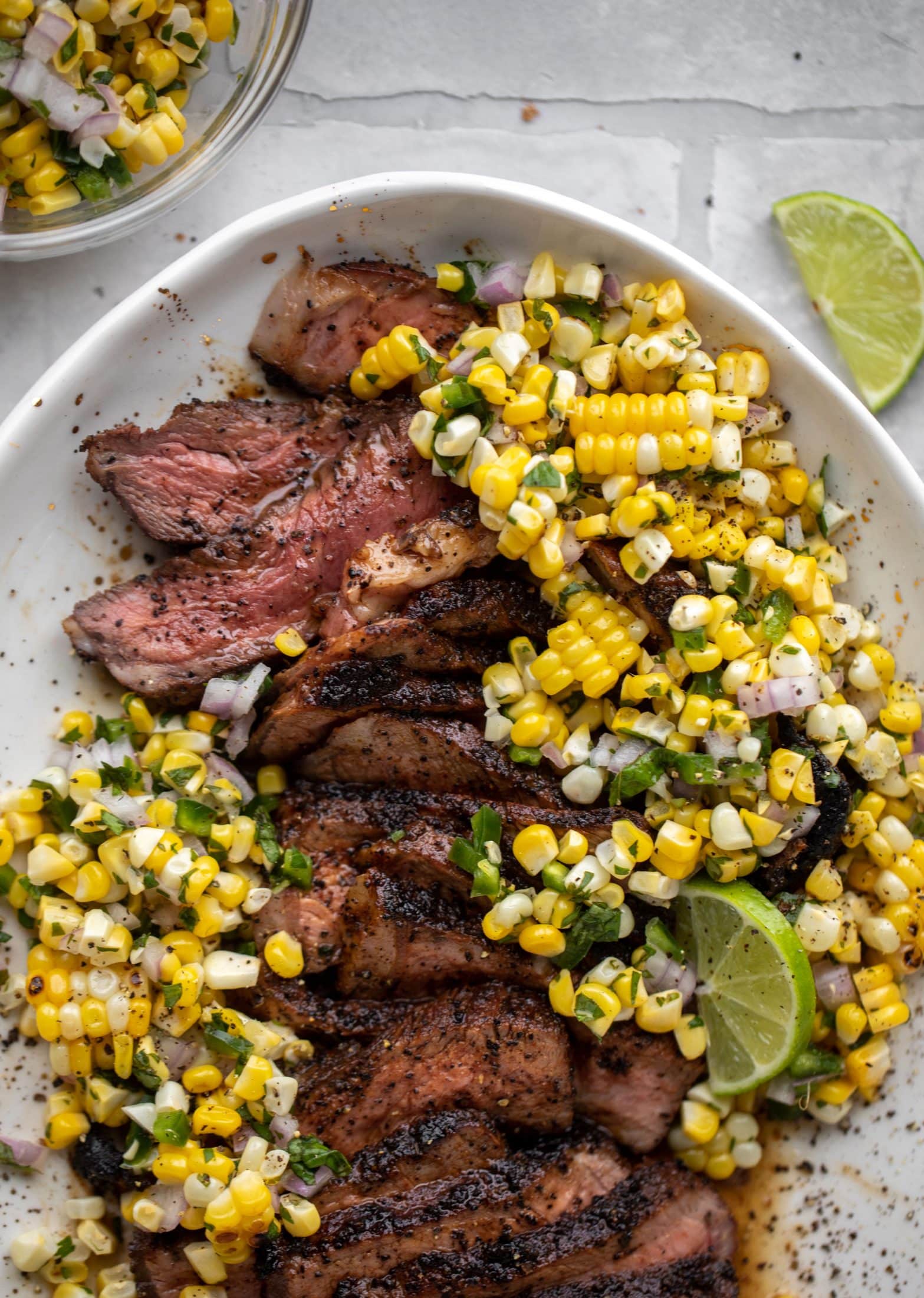 This coffee crusted steak is incredibly flavorful! Topped with a fresh and bright herbed corn salsa, it's the perfect meal to kick off summer.