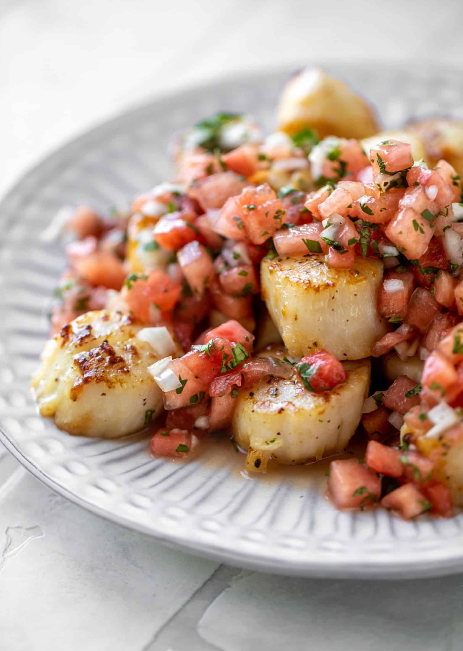 watermelon salsa over garlic butter scallops