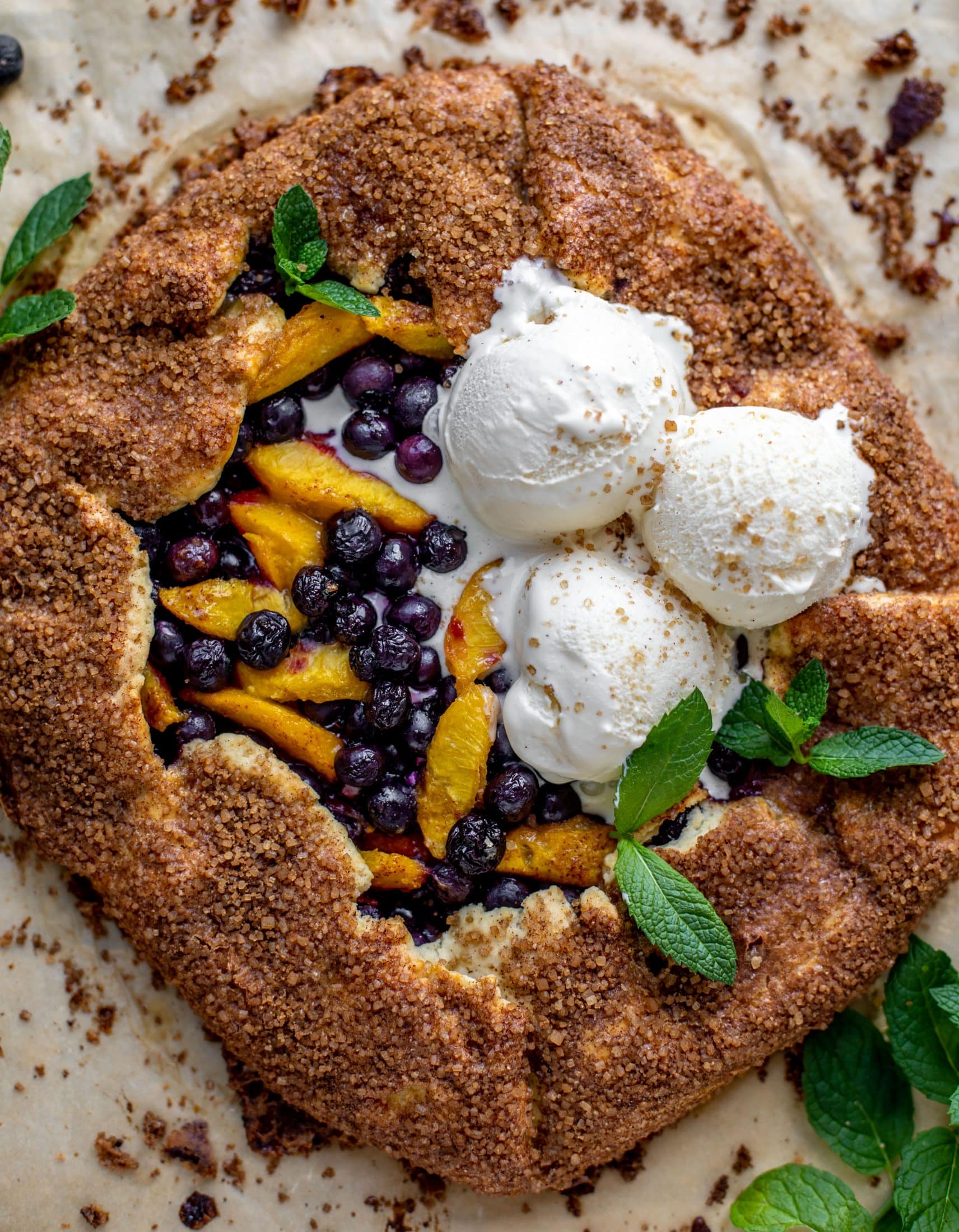 blueberry peach galette with cinnamon sugar galette topped with ice cream