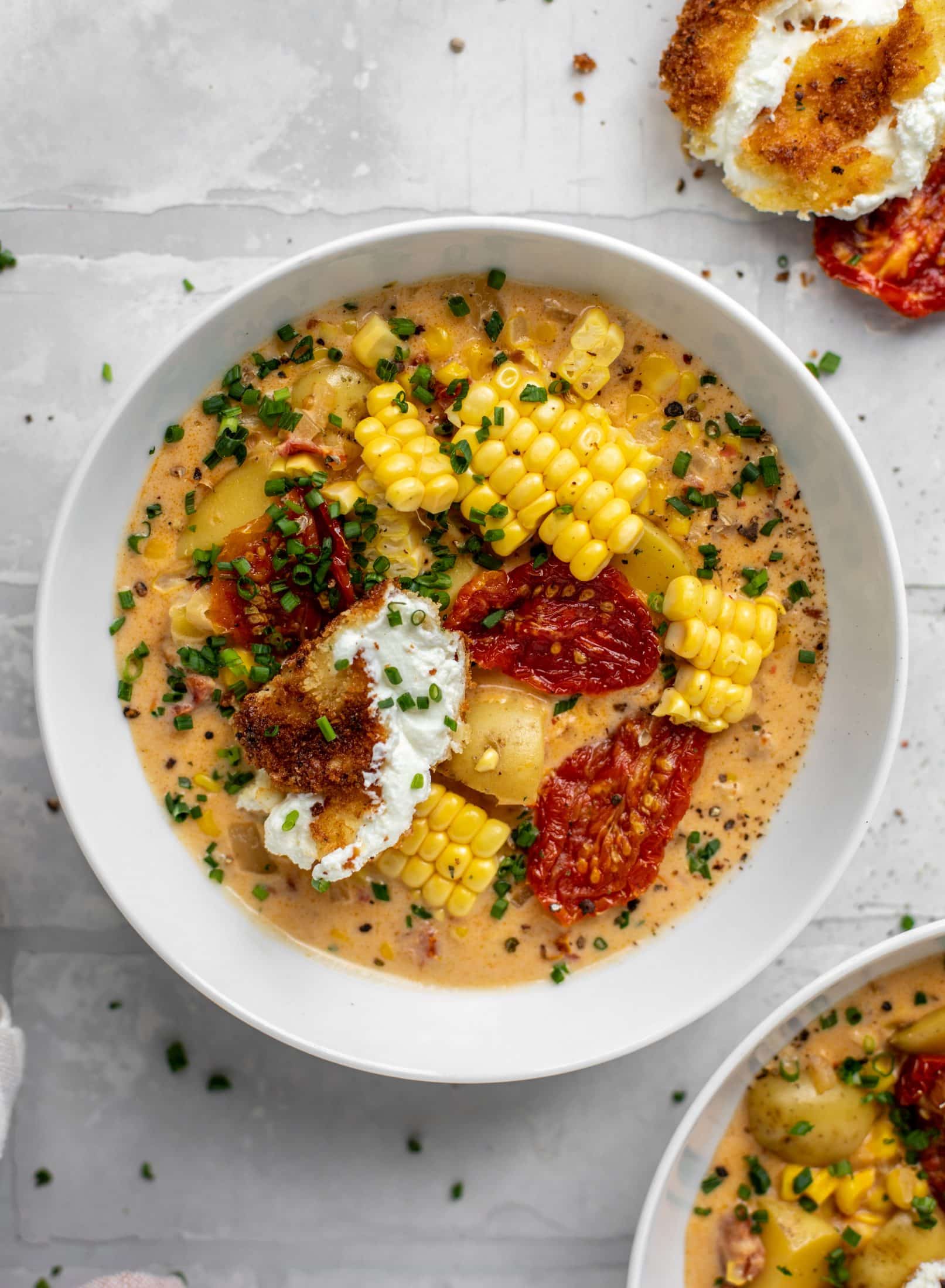 sun dried tomato corn chowder with crispy goat cheese