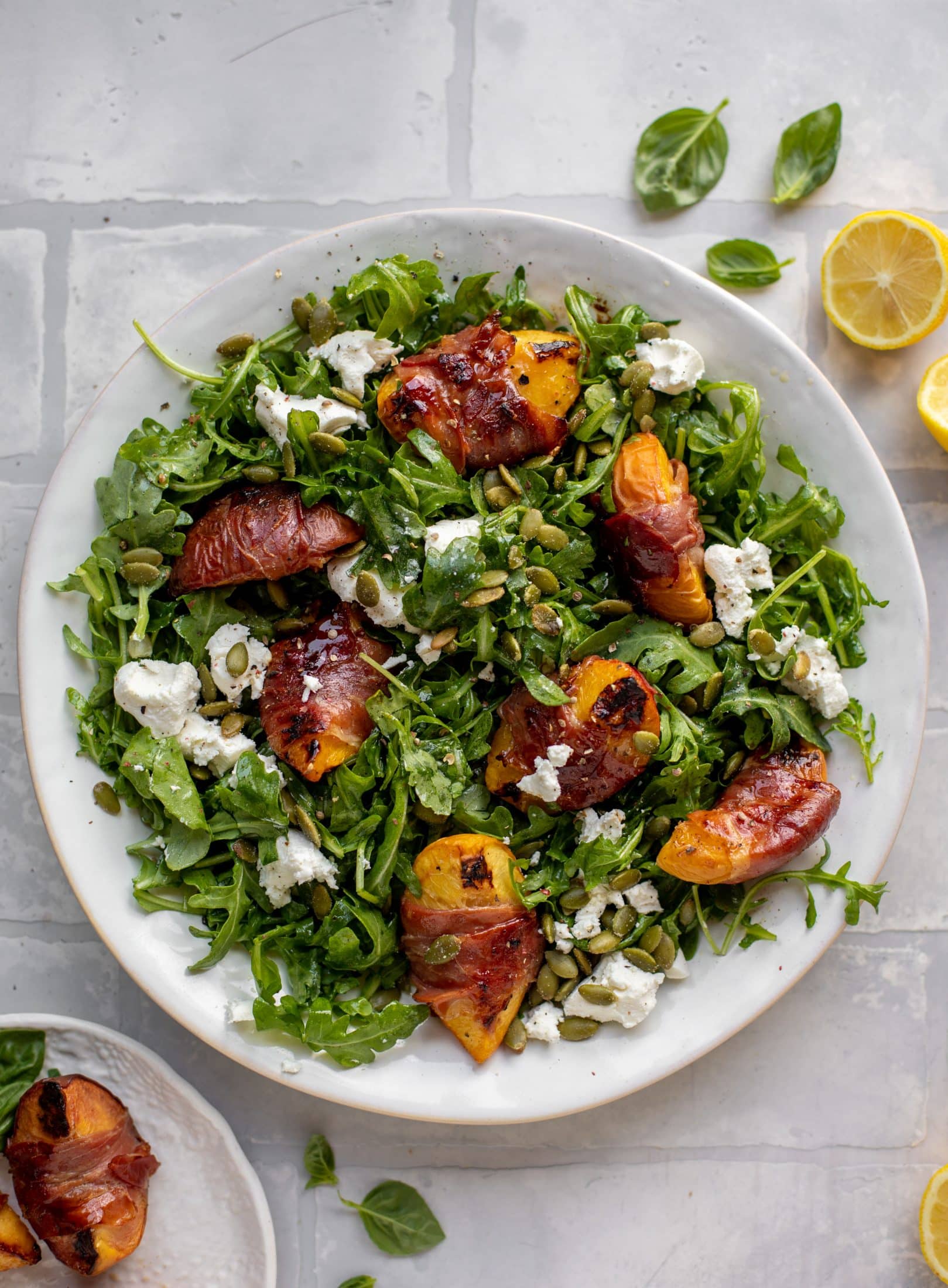 grilled prosciutto wrapped peaches with arugula and goat cheese