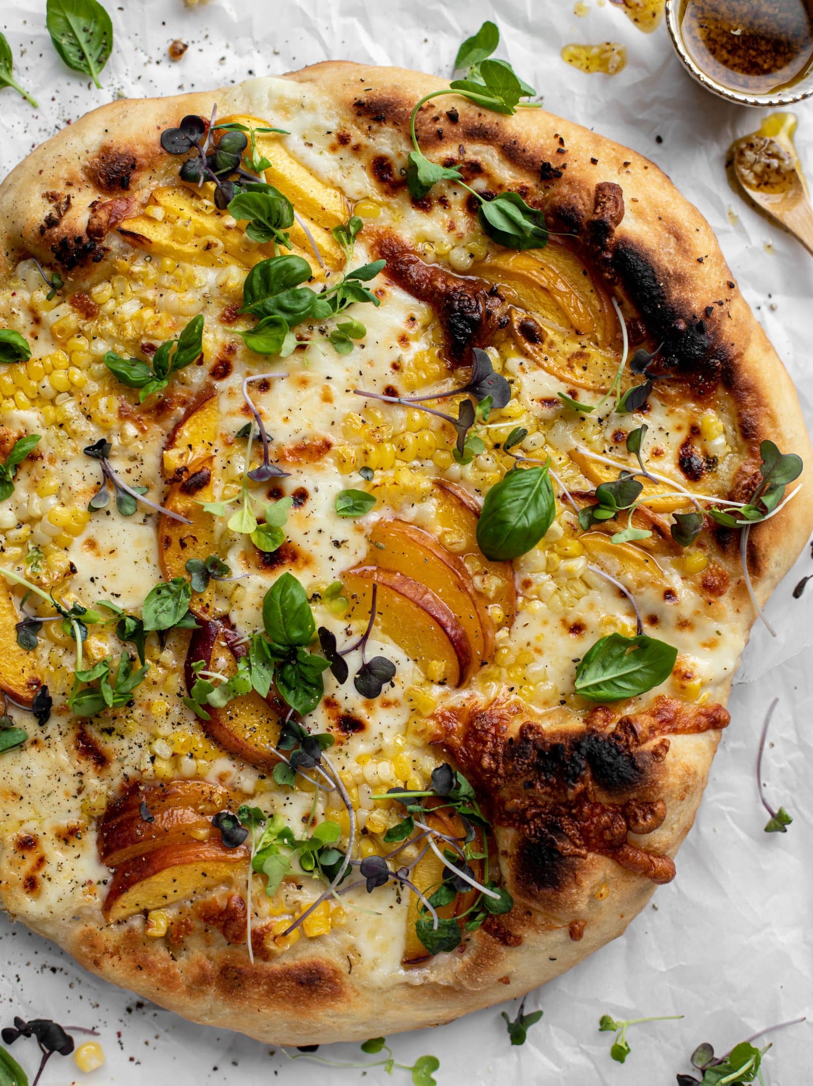 grilled peach pizza with corn and chili garlic oil
