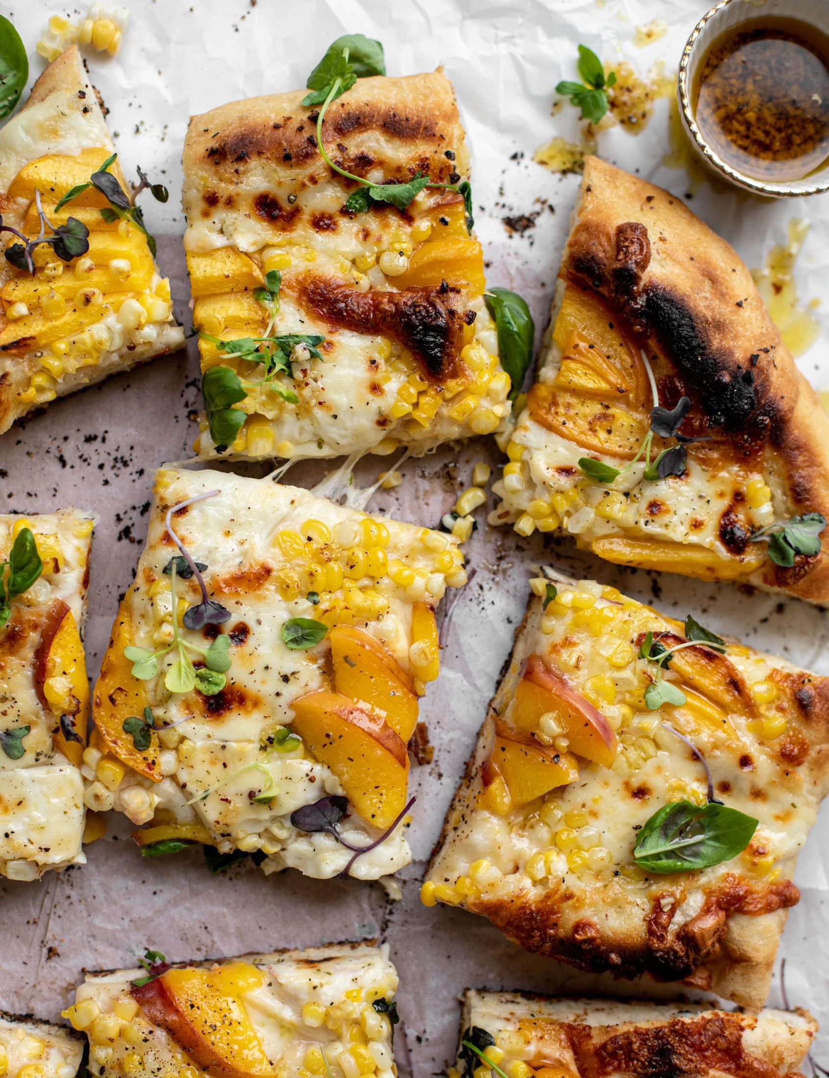 grilled peach pizza with corn and chili garlic oil