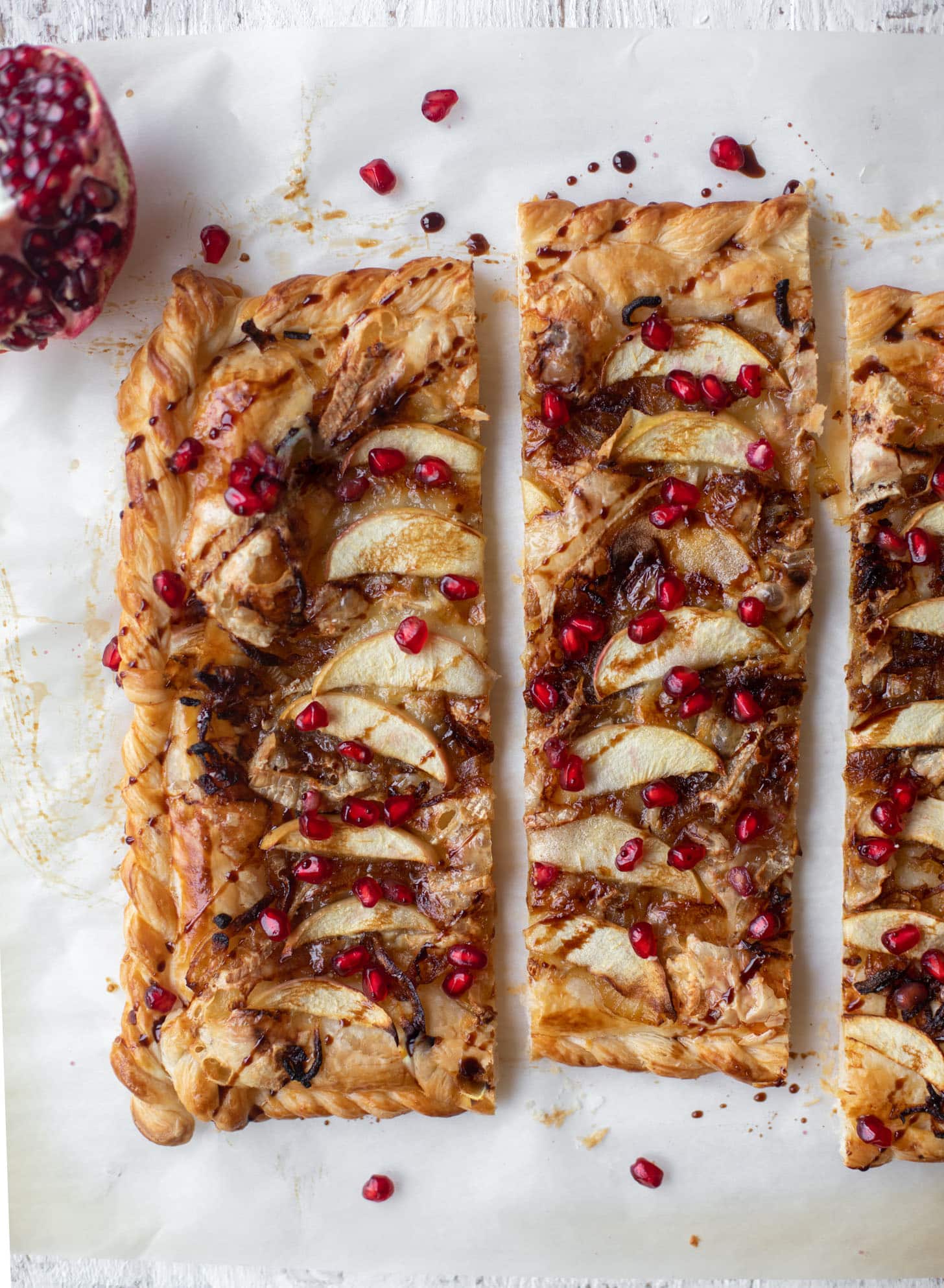 caramelized onion, apple and brie puff pastry tart with pomegranate molasses