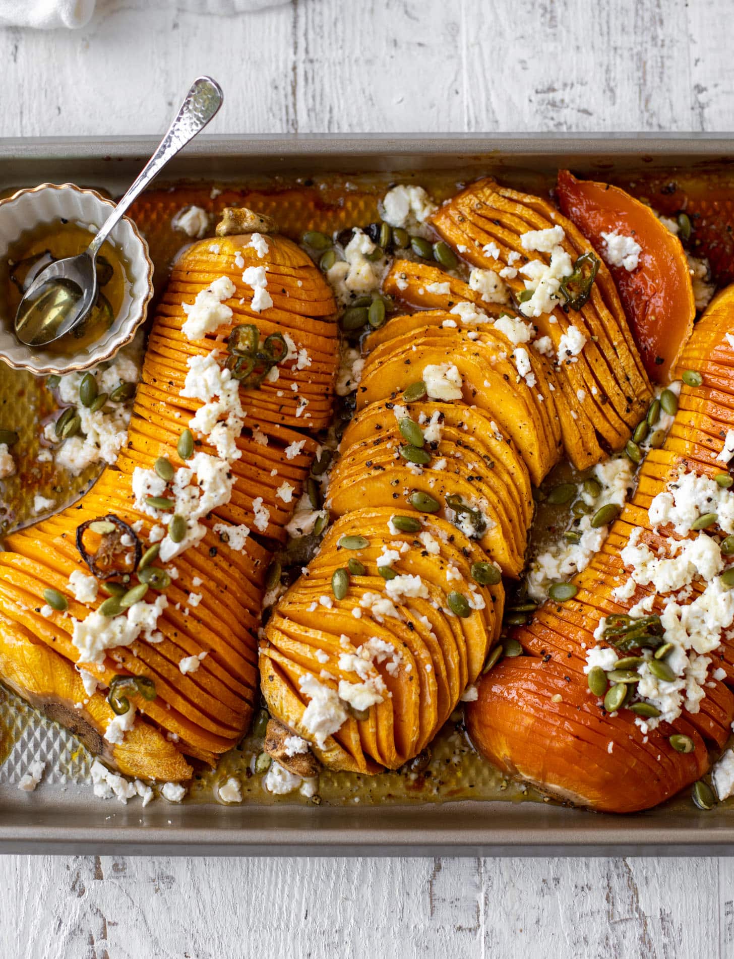 hot honey hasselback butternut squash with feta and pepitas